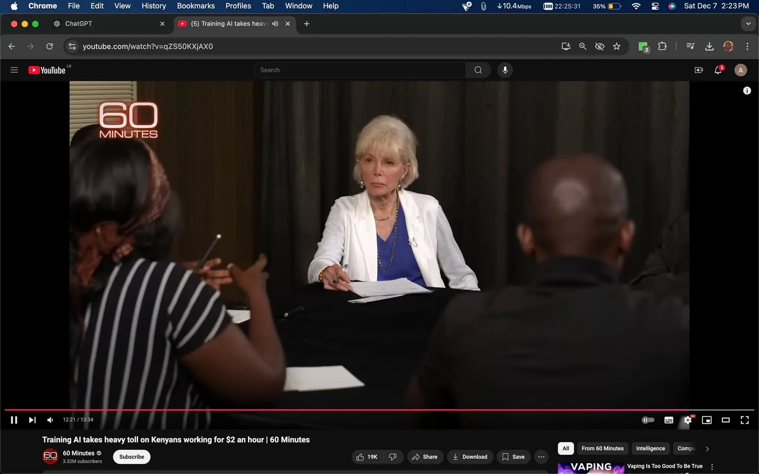 The screenshot is from a YouTube video titled "Training AI takes heavy toll on Kenyans working for $2 an hour | 60 Minutes," published by the channel "60 Minutes." The scene shows an interview setting, with a group discussion taking place around a black table. A woman in a white blazer and blue top, possibly the interviewer, is engaged in conversation with two other individuals. The individuals are partially visible, with one in a striped shirt gesturing and the other facing away from the camera. The mood appears serious and focused, typical of an investigative or in-depth interview format.

The backdrop is simple, with dark curtains, ensuring the focus remains on the conversation. Lighting is even, highlighting the participants and reinforcing the professional atmosphere. The "60 MINUTES" logo is prominently displayed on the left side of the image, indicating the brand and style of the program. This visual setup suggests a formal discussion on an important topic, likely the ethical and economic implications of AI training practices in Kenya as suggested by the title.