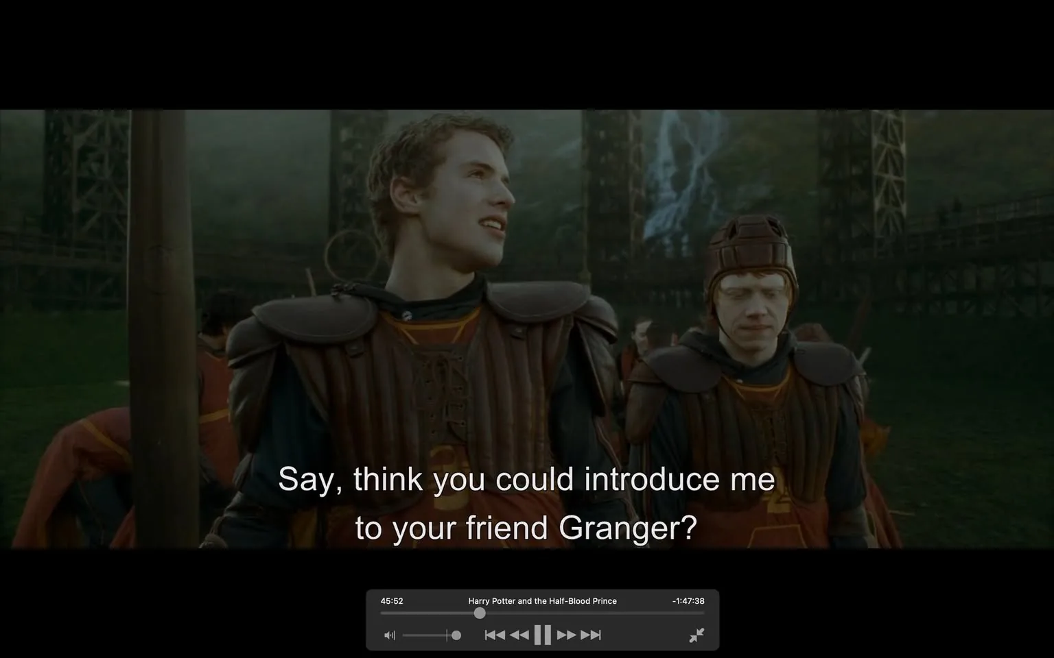 In the scene, two characters are engaged in conversation, with one asking the other if they could be introduced to a friend named Granger. The characters are dressed in brown and black uniforms that suggest a sporting or competitive context, possibly related to a fictional sport. The background features a dramatic landscape with structures that resemble a stadium or arena, hinting at an outdoor event. The atmosphere appears tense or competitive, as indicated by the expressions and postures of the characters. The dialogue is displayed prominently at the bottom of the image, enhancing the narrative context.