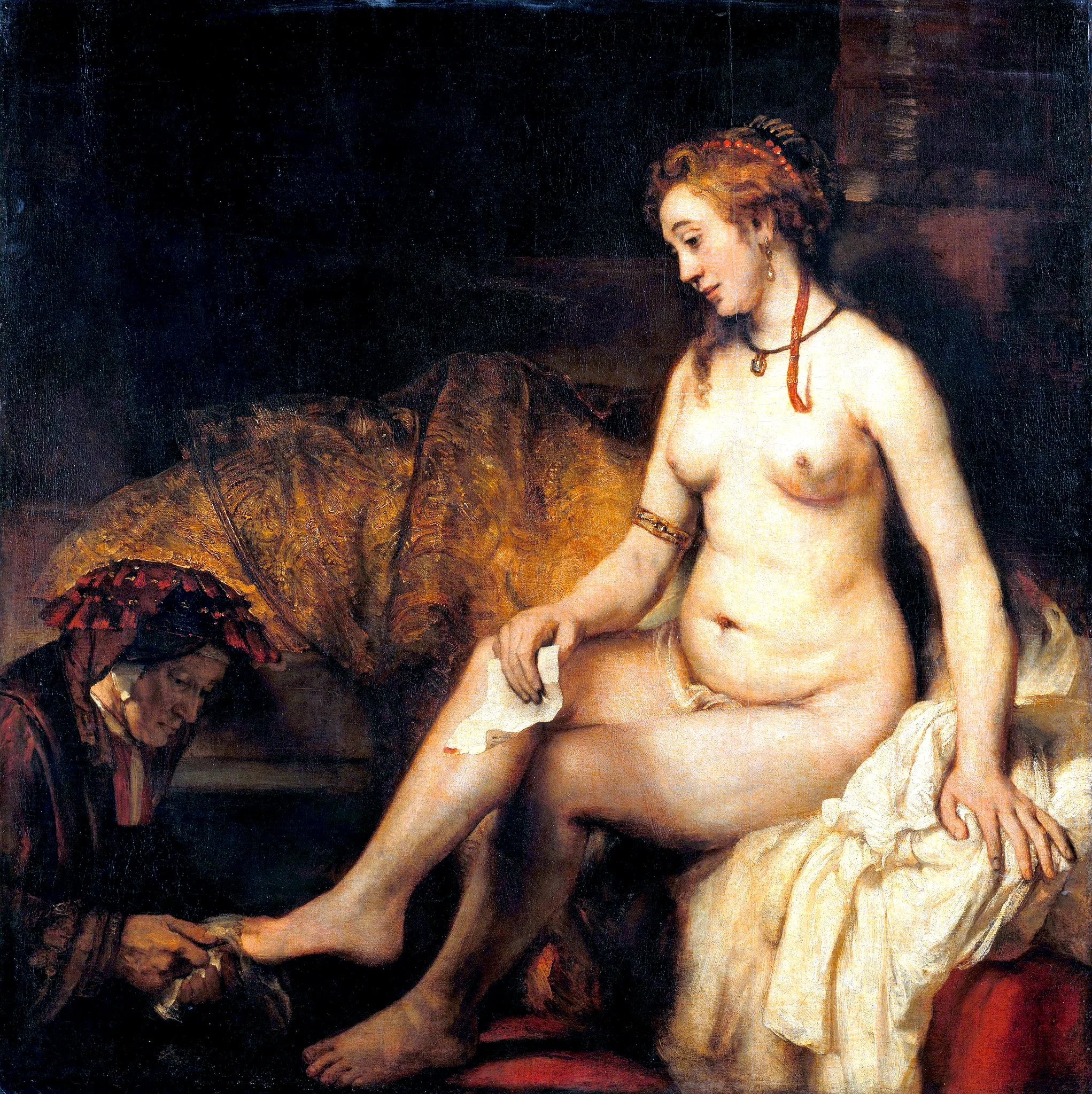 In the painting, a nude woman is seated gracefully, her body turned slightly to the side. She has long, flowing hair adorned with a red ribbon and is wearing jewelry, including a necklace and bracelets. Her expression is serene as she looks down at her foot, which is being attended to by an older woman kneeling beside her. The older woman is dressed in dark clothing with a head covering, focused on her task. The background features rich, textured fabrics in warm tones, creating an intimate atmosphere. The overall composition suggests a moment of care and tenderness, with the interplay of light and shadow enhancing the scene's depth.