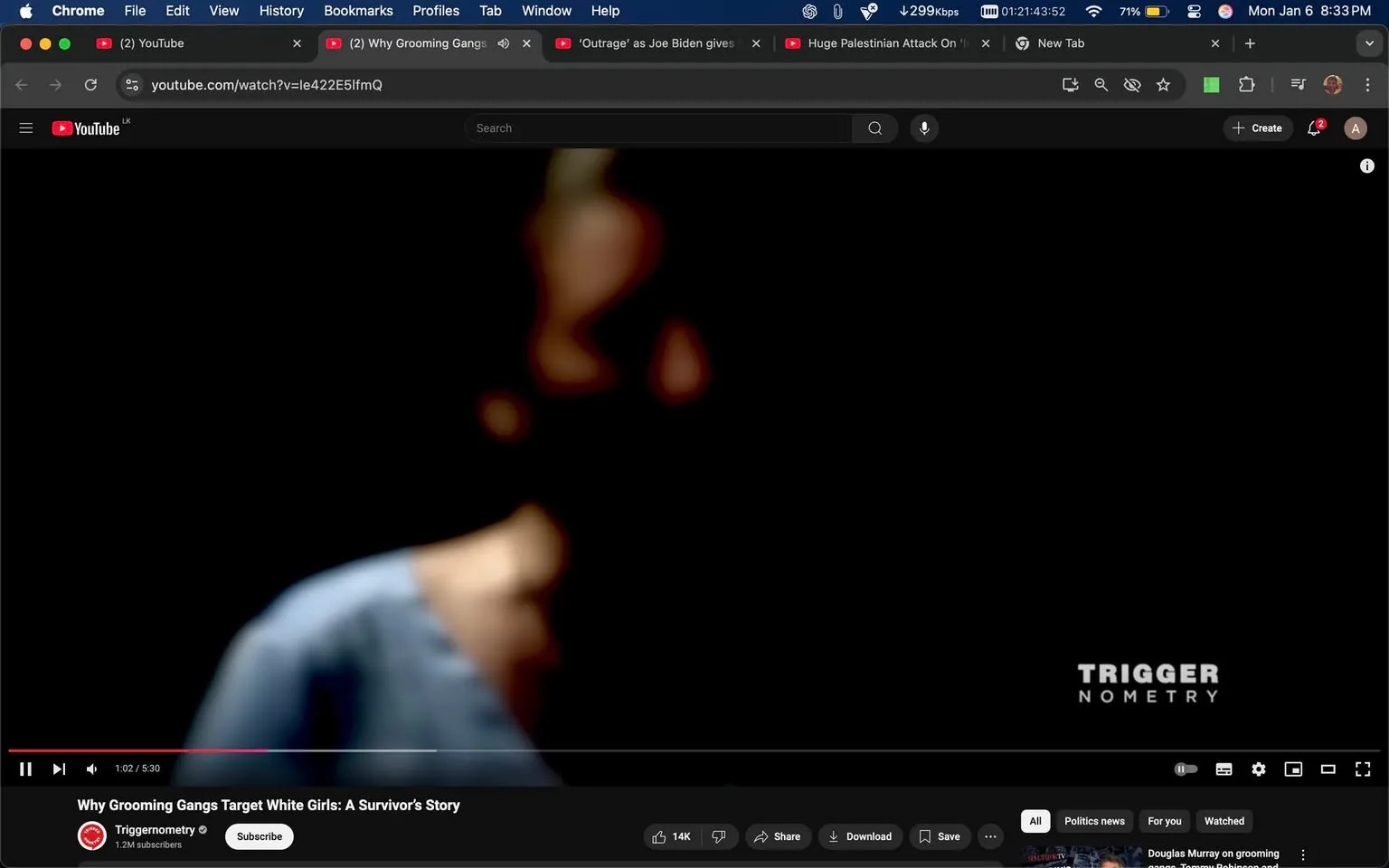In the image, a blurred figure is partially visible against a dark background, suggesting a focus on a person speaking or presenting. The figure appears to be wearing a blue garment, but details are obscured due to the blurriness. The video title, "Why Grooming Gangs Target White Girls: A Survivor's Story," is displayed prominently, indicating the subject matter of the content. The YouTube logo is visible in the corner, along with the channel name "Triggeometry," which has 1.2 million subscribers. The overall setting appears to be a video presentation, likely indoors, with no additional context or identifiable features in the background.