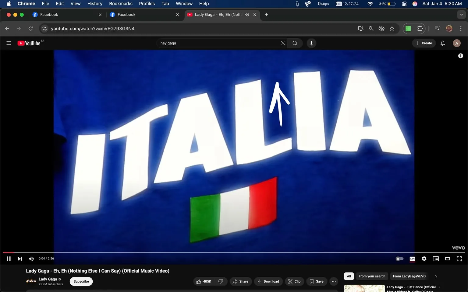 The image prominently displays the word "ITALIA" in large, bold white letters against a blue background. Below the text, there is a small representation of the Italian flag, which consists of three vertical stripes: green, white, and red. The flag is positioned to the right of the text. The overall design suggests a theme related to Italy, possibly linked to a cultural or musical context, as indicated by the surrounding text referencing Lady Gaga's song "Eh, Eh (Nothing Else I Can Say)." The image does not contain any identifiable individuals or explicit content.
