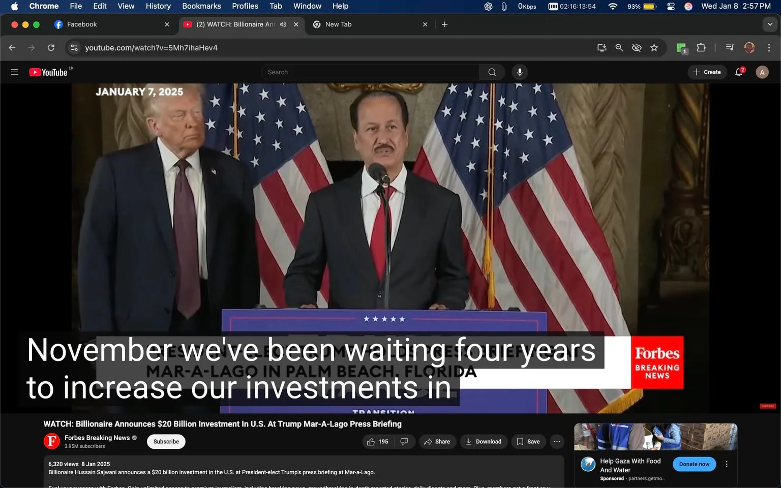 In the image, a press briefing is taking place at Mar-a-Lago in Palm Beach, Florida. An unidentified adult male is speaking at a podium, wearing a suit with a red tie, while another unidentified adult male stands beside him, appearing to listen. The backdrop features multiple American flags. The visible text on the screen indicates that the event is related to a significant investment announcement, specifically mentioning a $20 billion investment in the U.S. The date displayed is January 7, 2025. The setting appears formal, likely indicating a political or business context. The logo of Forbes is visible, suggesting that this is a news-related event.