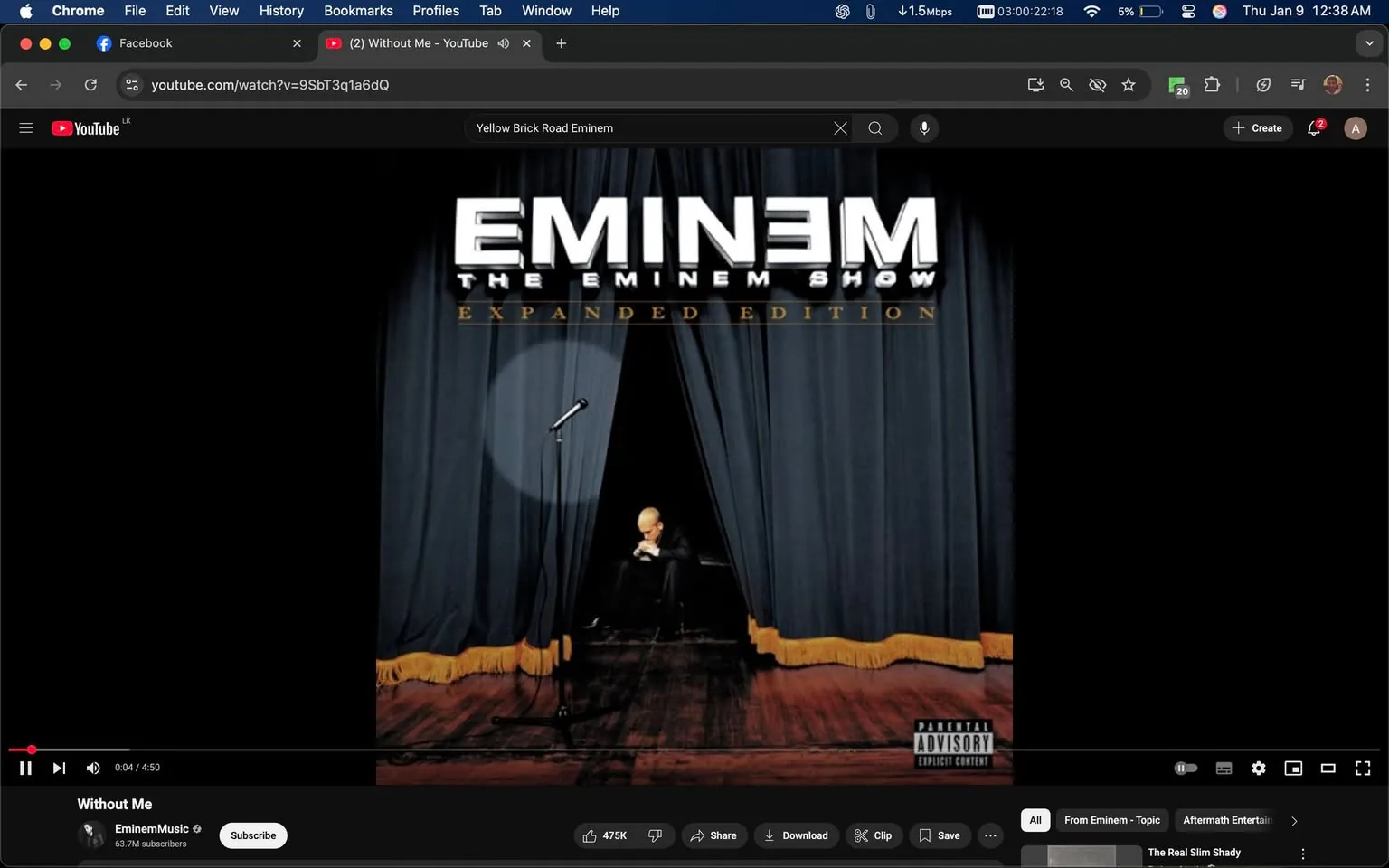 The image displays the album cover for "The Eminem Show (Expanded Edition)" by Eminem. The cover features a dark stage with heavy blue curtains drawn back, revealing a spotlight illuminating a seated figure. The figure appears to be a man with light-colored hair, dressed in black, sitting on a wooden stage. The album title "EMINEM" is prominently displayed at the top in bold white letters, while "THE EMINEM SHOW" is written in a smaller font beneath it. The words "EXPANDED EDITION" are also visible in gold lettering. The overall mood of the cover suggests a theatrical or performance setting, with a microphone stand positioned to the side.