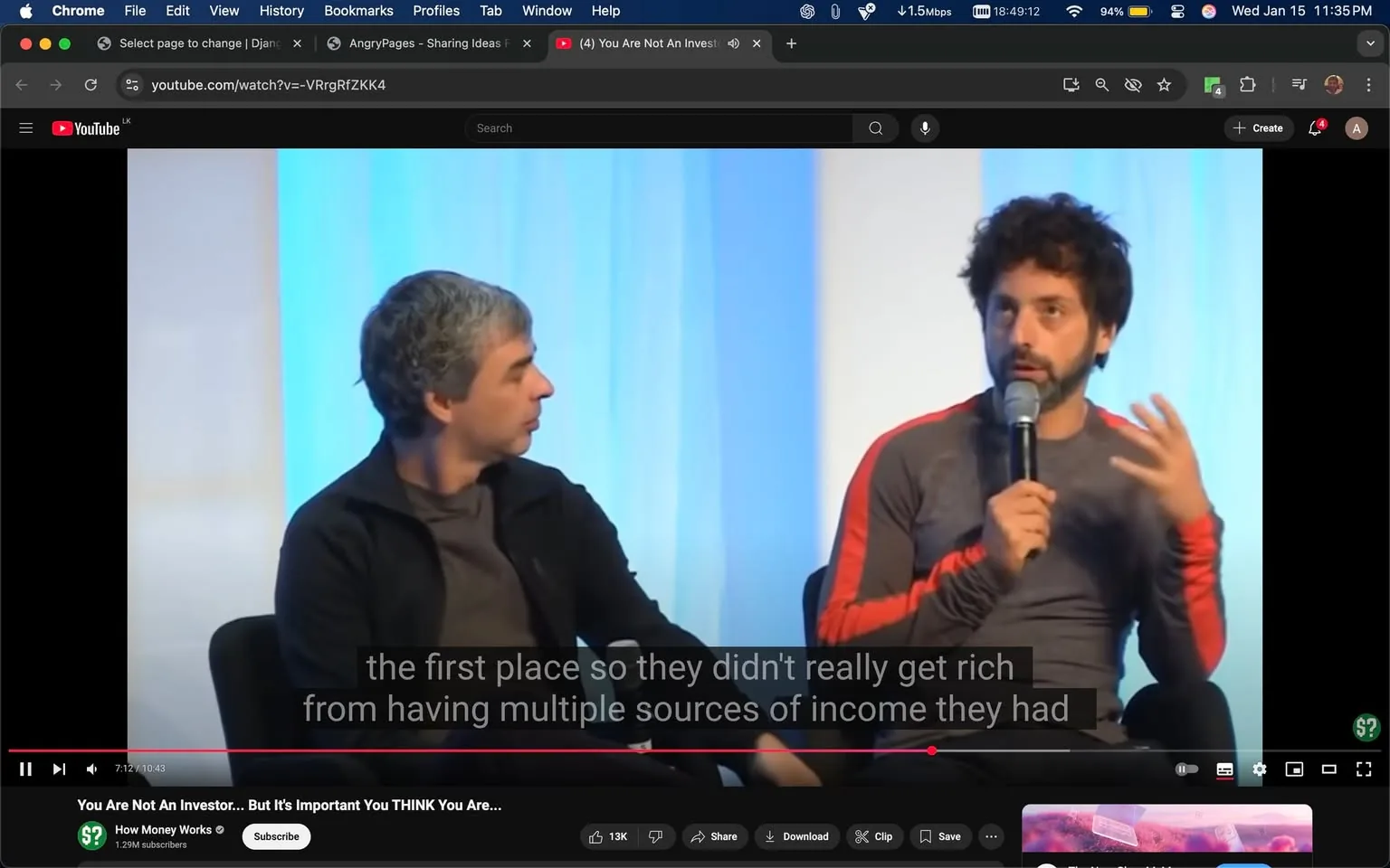 In the image, two unidentified adults are seated on stage, engaged in a discussion. One individual, wearing a dark jacket, appears to be listening attentively while the other, dressed in a fitted gray shirt with red accents, is speaking into a microphone. The background features a softly lit blue backdrop, suggesting a professional or conference setting. The speaker gestures with his hands, emphasizing his points. Subtitles are visible at the bottom of the screen, indicating a conversation about wealth and income sources. The overall atmosphere seems focused and serious, typical of a panel discussion or interview format.