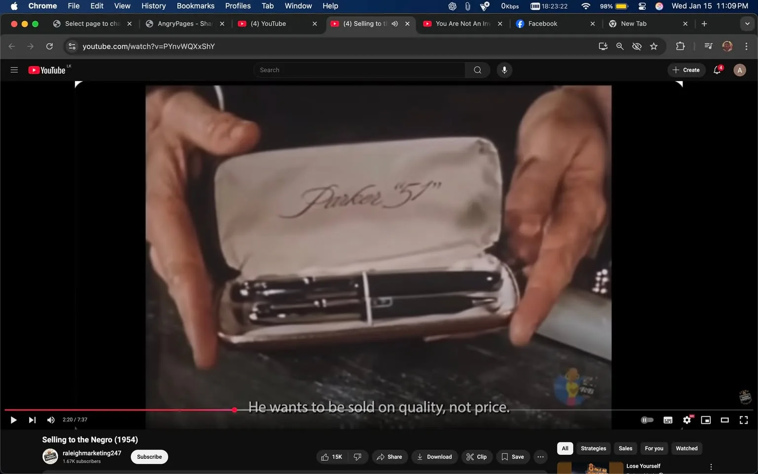 In the image, a hand is holding an open case containing a pen set. The interior of the case is lined with a soft material, and the brand name "Parker" is elegantly scripted on the inside lid. The pens are black and silver, showcasing a classic design. The setting appears to be indoors, likely at a table or desk, with a dark surface beneath the case. The focus is on the pen set, suggesting a presentation or demonstration of quality writing instruments. There are no visible people or additional context in the background.