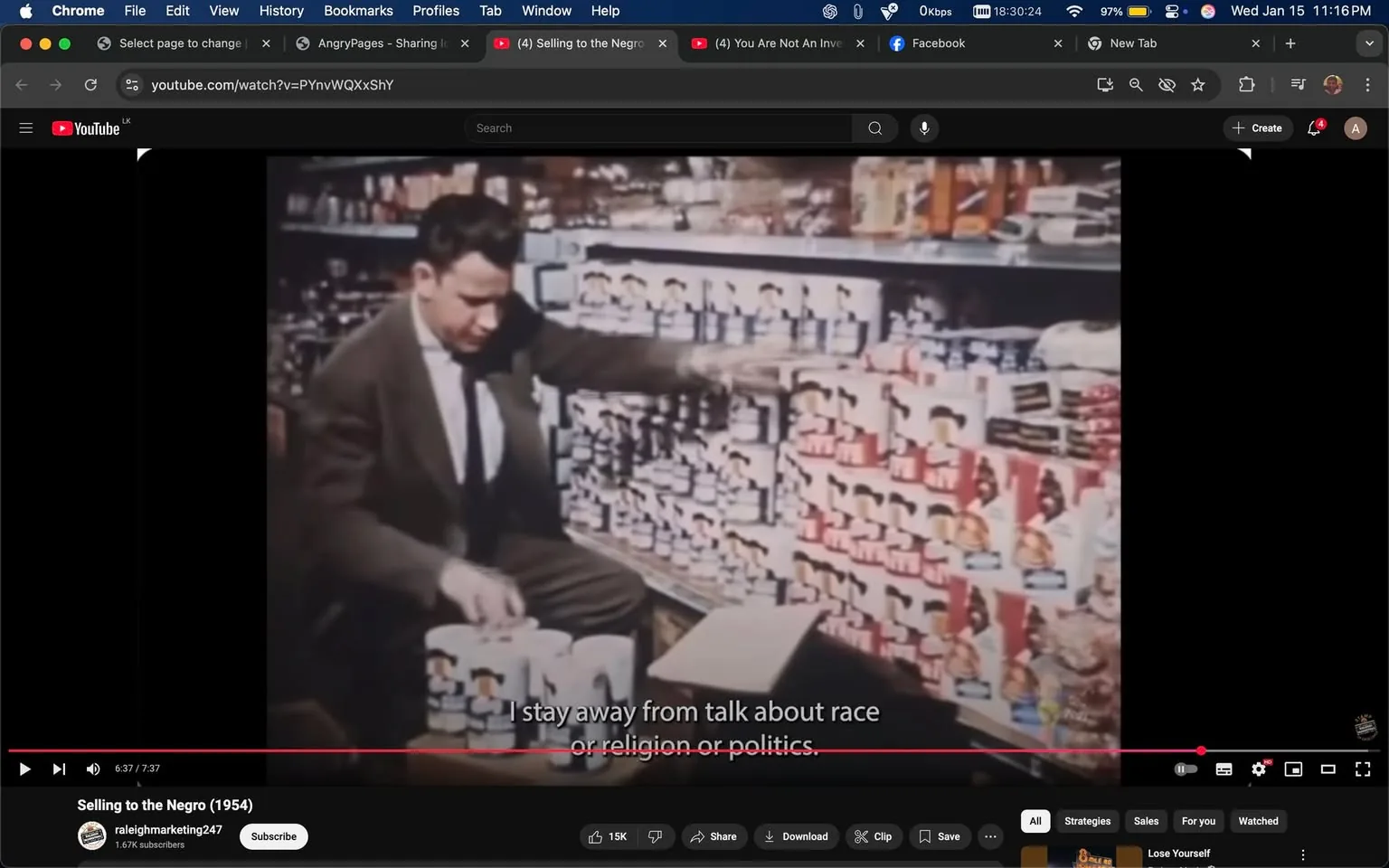 In the image, an unidentified adult male is seated in a grocery store aisle, interacting with various canned goods. He appears to be in the process of organizing or selecting items from a shelf filled with colorful cans, prominently displaying the brand "Pork and Beans." The setting is indoors, likely during daylight, as indicated by the bright lighting. The man is dressed in a suit and tie, suggesting a formal appearance. Text overlay on the image states, "I stay away from talk about race or religion or politics," indicating a discussion or commentary related to social topics. The background is filled with shelves stocked with various food products, creating a busy retail environment.