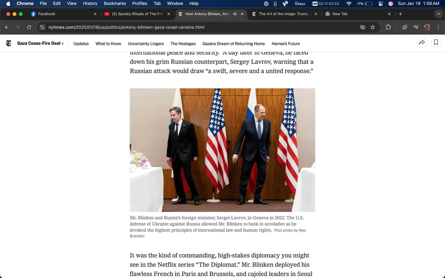 In the image, U.S. Secretary of State Antony Blinken and Russian Foreign Minister Sergey Lavrov are present in a formal diplomatic setting, likely during a meeting in Geneva in 2022. Blinken is dressed in a dark suit and tie, appearing to walk away from Lavrov, who is also in a dark suit. The two men are positioned on either side of the image, with the flags of the United States and Russia prominently displayed behind them. The U.S. flag is on the left, while the Russian flag is on the right. 

The setting appears to be indoors, with a neutral-colored background and a table partially visible in the foreground, adorned with a white tablecloth and some floral arrangements. The expressions of both officials are serious, reflecting the high-stakes nature of their discussions. The overall atmosphere suggests a tense diplomatic exchange, as indicated by their body language and the formal attire. There are no visible signs of violence or sexual content in the image, and it focuses solely on the diplomatic interaction between the two figures.