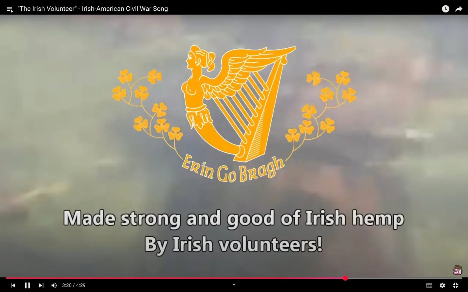 The image prominently features the phrase "Erin Go Bragh" along with a stylized depiction of a woman with wings, holding a harp. This design is surrounded by decorative elements, including shamrocks. Below the logo, the text reads, "Made strong and good of Irish hemp by Irish volunteers!" The background appears to be a blurred, soft-focus gradient, which does not distract from the central elements. The overall theme suggests a connection to Irish heritage and possibly a historical context related to the Irish-American Civil War song titled "The Irish Volunteer." There are no visible brands or logos apart from the artistic representation.