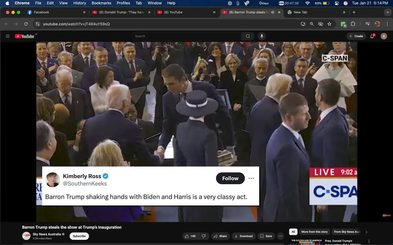 In the image, a significant moment is captured during a formal event, likely an inauguration. Prominent figures are present, including Joe Biden, who is seen shaking hands with a younger individual, possibly Barron Trump. The setting appears to be indoors, with a large crowd in attendance, many of whom are dressed in formal attire, indicating the importance of the occasion. The background features a mix of expressions, with some attendees clapping and others observing intently. 

The visible text on the screen includes a tweet from Kimberly Ross, commenting on Barron Trump’s interaction with Biden and Harris, describing it as a "very classy act." This suggests a moment of unity or civility amidst a politically charged atmosphere. The overall tone of the gathering seems to be one of celebration and formality, typical of an inauguration event. The presence of various political figures and the formal attire of the attendees further emphasize the significance of the occasion.