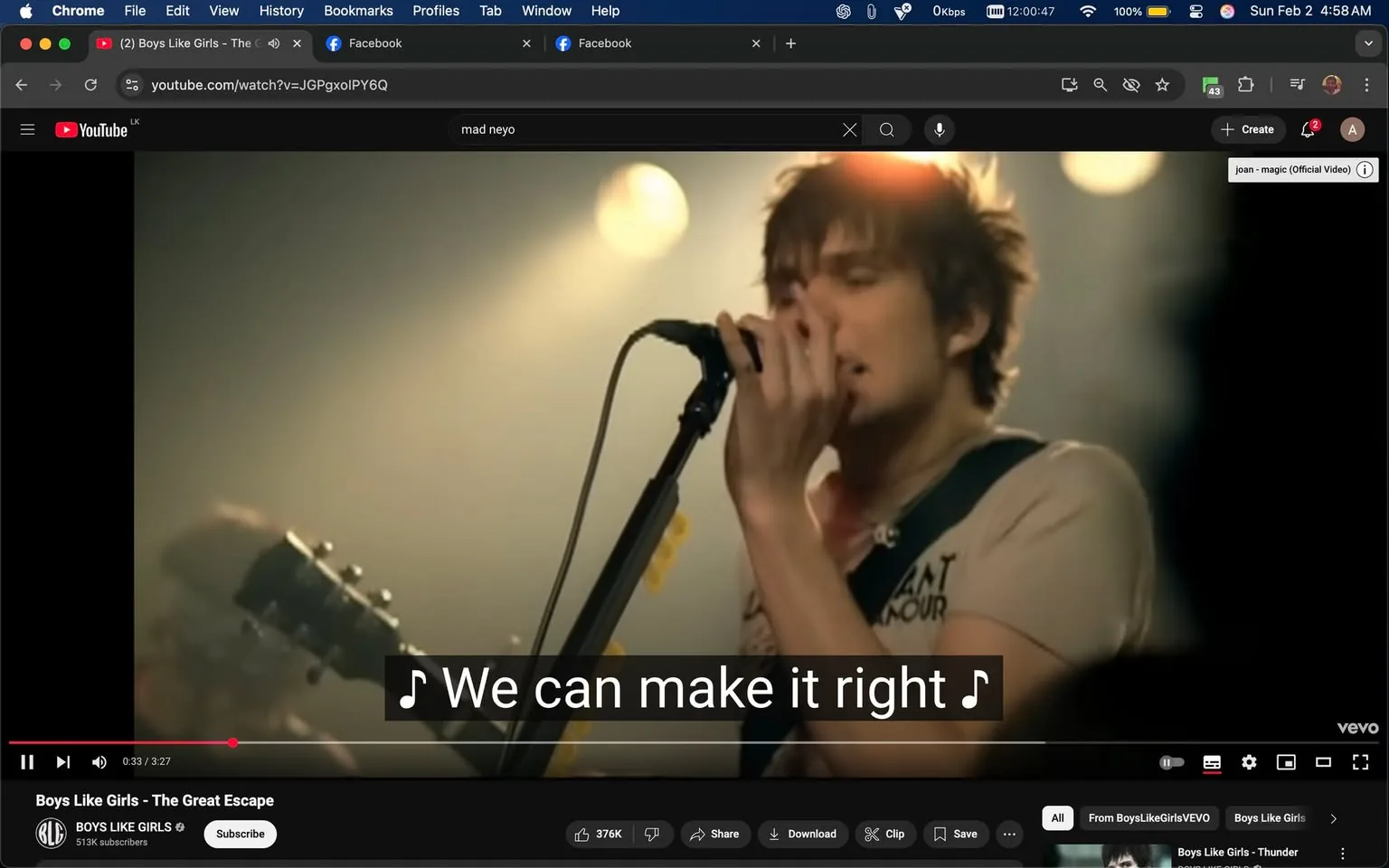 The scene captures a male singer passionately performing on stage, holding a microphone close to his mouth. He has tousled hair and is dressed in a light-colored shirt with a graphic design. The background is softly illuminated with warm lighting, creating a vibrant atmosphere typical of a live music performance. A guitar is visible in the frame, suggesting a band setting. The singer appears to be in mid-performance, conveying emotion through his expression and body language. 

The video is part of a song titled "The Great Escape" by Boys Like Girls, as indicated by the text overlay at the bottom of the screen. The lyrics displayed read, "We can make it right," which adds to the overall theme of the performance. The setting is likely an indoor venue, given the stage lighting and the intimate feel of the scene. There are no visible brands or logos in the image, and the overall mood is energetic and engaging, typical of a pop-rock concert.