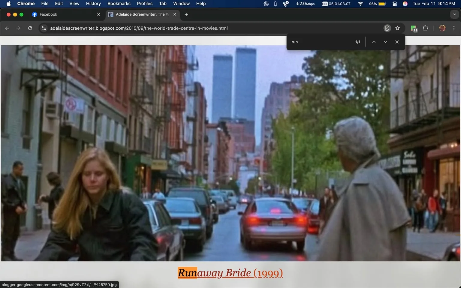 The image depicts a street scene from the movie "Runaway Bride" (1999). In the foreground, a woman with long, straight blonde hair is seen walking on the sidewalk. She is wearing a black jacket and appears to be focused on her surroundings. To her left, a man in a light-colored coat is looking back towards her, suggesting a moment of interaction or observation. 

The street is lined with parked cars, primarily in muted colors like gray and black, with a few trees visible along the sidewalk. The background features a cityscape with tall buildings, prominently displaying the Twin Towers of the World Trade Center, which are visible in the distance. The sky appears overcast, contributing to a somewhat subdued atmosphere.

On the left side of the image, there are signs and storefronts, although the text on these signs is not clearly legible. The street itself is bustling with activity, as several pedestrians can be seen walking along the sidewalk, indicating a lively urban environment. 

The overall composition captures a moment in a city setting, with a focus on the characters and their interactions amidst the backdrop of New York City. The image conveys a sense of movement and life typical of a busy street scene.