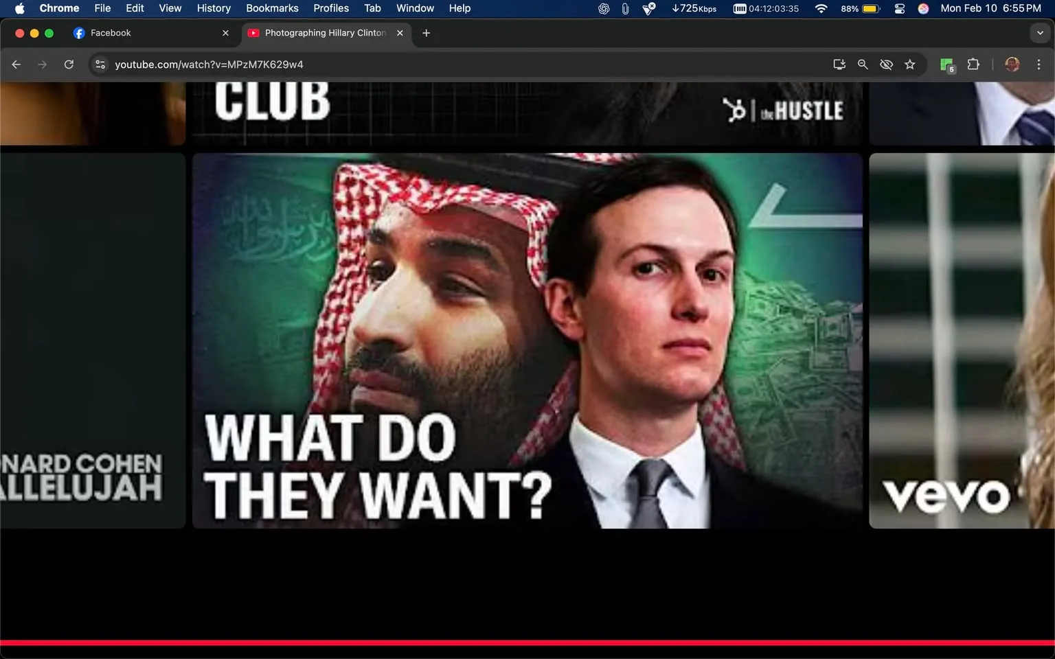 The image features two individuals, one wearing traditional Middle Eastern attire and the other in a suit. The prominent text reads "WHAT DO THEY WANT?" and there is a logo for "vevo" present. There are no visible objects or specific setting details. The content does not contain any sexual, violent, or drug-related themes, and there are no minors present. The overall assessment is Tier 1, indicating it is suitable for general audiences.
