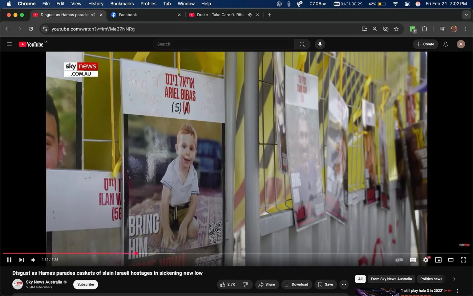 The image depicts a series of posters displayed on a yellow backdrop, likely part of a public awareness campaign. The posters are attached to a fence or wall, with some visible yellow ribbons or ties securing them.

1. **Readable Text**: 
   - One poster features the name "ARIEL BIBAS" prominently, along with the age "5" and a number in parentheses. The text appears to be in Hebrew and English.
   - Another poster has the phrase "BRING HIM HOME NOW!" in bold letters, indicating a call to action.
   - Additional posters contain various images of individuals, but the text is not clearly legible in this image.

2. **Visible Objects**: 
   - The posters are printed on paper and feature photographs of individuals, including a young child with light brown hair, wearing a white shirt and sitting on the ground.
   - The background of the posters includes a patterned surface, possibly a rug or mat.

3. **Clothing and Appearance**: 
   - The child in the foreground is dressed in a simple white shirt and shorts, appearing to be in a playful position.
   - Other individuals in the posters are not clearly visible, but they appear to be adults based on the context.

4. **Setting and Background**: 
   - The setting appears to be an outdoor area, possibly a public space or a demonstration site, given the nature of the posters.
   - The yellow background suggests a bright and possibly attention-grabbing environment, with the posters arranged in a somewhat organized manner.

5. **Environmental Context**: 
   - The overall atmosphere seems to be one of urgency and concern, as indicated by the content of the posters, which likely relate to missing persons or a call for action regarding hostages.

The image captures a moment of public engagement, focusing on the plight of individuals represented in the posters, emphasizing the emotional weight of the situation through the visual presentation.