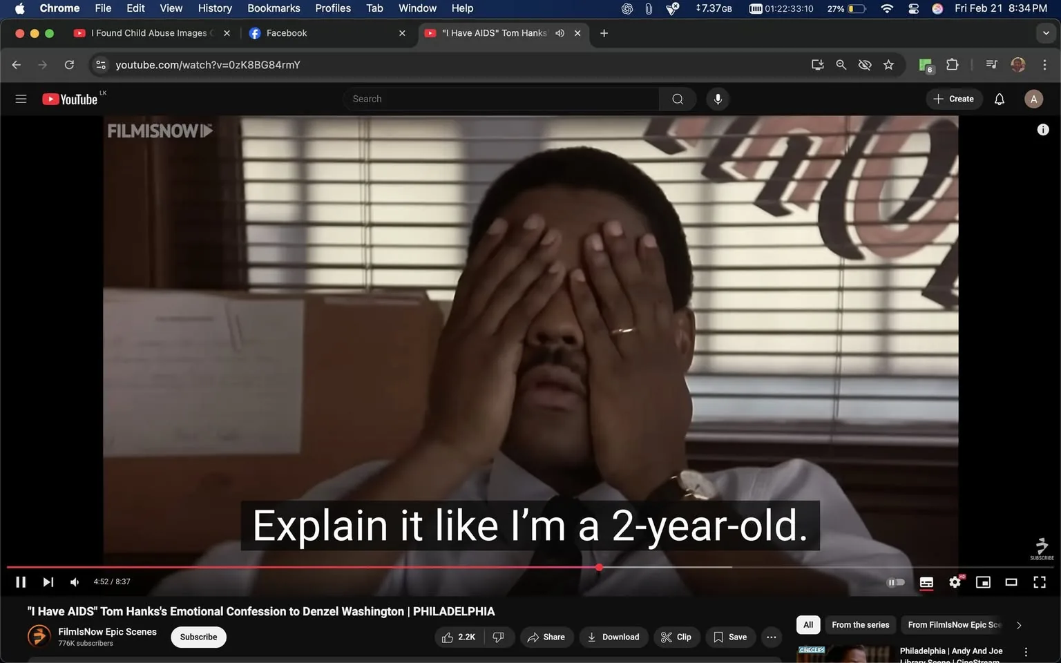 The image depicts a scene from a film featuring a man sitting at a desk. He has his hands covering his face, suggesting a moment of distress or contemplation. The man is wearing a light-colored dress shirt and a dark tie, with a wedding band visible on his left hand. His facial expression is obscured due to his hands, but the posture indicates a serious or overwhelmed demeanor.

In the background, there are vertical blinds that allow some light to filter through, creating a striped pattern on the man's face and upper body. The setting appears to be an office, as indicated by the desk and the presence of a cardboard box behind him. There is also a piece of paper or a document visible on the desk, although the text is not legible.

At the bottom of the image, there is a subtitle that reads, "Explain it like I'm a 2-year-old." This text is in white font against a black background, indicating it is part of a video playback interface. The video is titled "I Have AIDS" and features Tom Hanks's emotional confession to Denzel Washington, suggesting the scene is from the film "Philadelphia."

The video player interface includes standard controls such as play, pause, and volume, along with a progress bar indicating the current playback time of 4:52 out of 8:37. The logo "FILMSNOW" is visible in the upper left corner, indicating the source of the video. The overall atmosphere of the image suggests a serious and emotional moment within the context of the film.