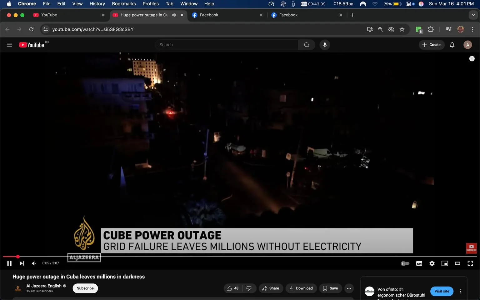 The image is a screenshot from a YouTube video titled "Huge power outage in Cuba leaves millions in darkness," uploaded by Al Jazeera English. The video is currently playing, with a duration of 3 minutes and 7 seconds. The visible portion of the video shows a dark urban landscape, likely depicting a street or neighborhood affected by the power outage. 

In the foreground, there are several buildings, most of which are shrouded in darkness. A few lights can be seen in the background, possibly from distant buildings or vehicles, indicating some areas still have electricity. The street appears empty, with no visible pedestrians or vehicles in the immediate vicinity. 

The lower part of the image features a news banner that reads "CUBE POWER OUTAGE" in bold, white text, followed by "GRID FAILURE LEAVES MILLIONS WITHOUT ELECTRICITY" in smaller text. The Al Jazeera logo is present in the top left corner, featuring a stylized flame-like design in gold, accompanied by the text "Al Jazeera" in black.

The browser interface at the top shows that the user is on YouTube, with tabs for Facebook and other applications open. The time displayed is 4:01 PM, and the battery percentage is 75%. The video has 48 likes and options to share, download, or save it. 

Overall, the image captures a moment of a news report focusing on a significant power outage in Cuba, with a somber and serious tone conveyed through the dark visuals and the news banner.