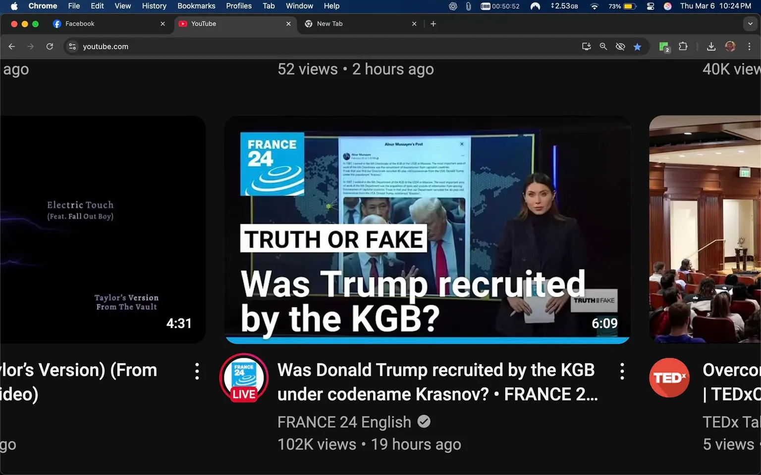The image displays a YouTube interface featuring a video thumbnail from the channel "FRANCE 24 English." The video is titled "Was Trump recruited by the KGB?" and is categorized under "Truth or Fake." The thumbnail includes a prominent white text overlay stating "TRUTH OR FAKE" in a bold font, positioned at the top of the image. Below this, the title of the video is presented in a smaller font, stating, "Was Donald Trump recruited by the KGB under codename Krasnov?"

In the background of the thumbnail, there is a digital display featuring a post from a user named Alnur Musayev, which appears to be a social media post discussing Donald Trump. The post is partially obscured, but it seems to include text and possibly an image related to Trump. To the right of this display, there is a man who resembles Donald Trump, identifiable by his distinctive hairstyle and suit, standing next to another individual who is not clearly identifiable.

In the foreground, a woman is visible, dressed in a dark turtleneck and blazer, with long brown hair. She is holding a piece of paper and appears to be presenting or discussing the content of the video. Her expression is neutral, and she is looking directly at the camera.

The video has a view count of 102K and was uploaded 19 hours ago, as indicated in the lower section of the thumbnail. The overall color scheme of the thumbnail is dark, with blue and white accents, and the logo for "FRANCE 24" is visible in the top left corner, featuring a blue circular design with waves.

The setting appears to be a news studio or a digital news presentation environment, indicated by the background graphics that resemble a world map or data visualization. The overall layout is typical of a news broadcast, with a focus on delivering information visually and engagingly.