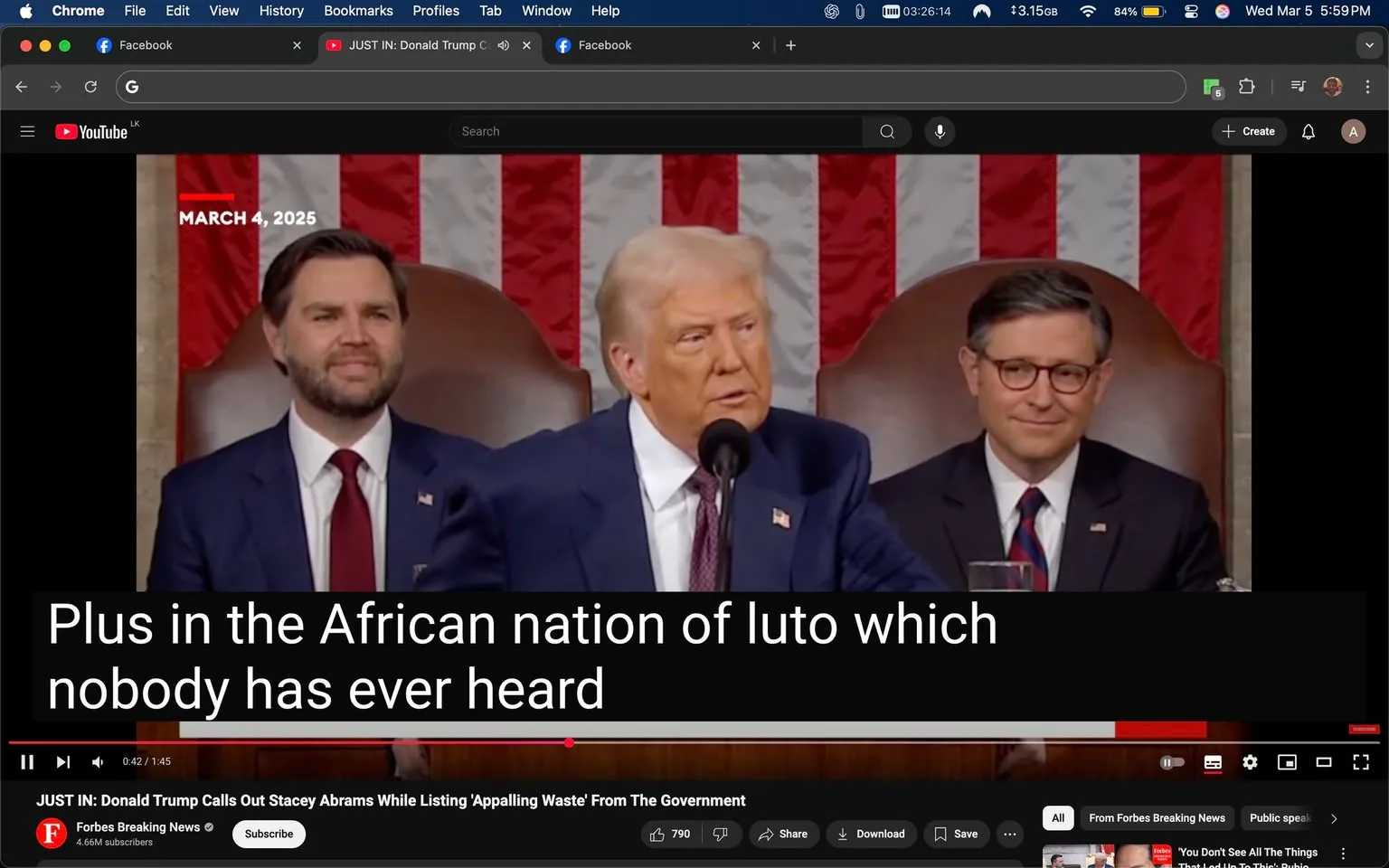 The image depicts a scene from a video, likely a speech or address, featuring three men seated at a table. The background consists of a large American flag, prominently displayed with red and white stripes and a blue field in the upper left corner containing white stars.

1. **Readable Text**: 
   - At the top left, there is a date displayed: "MARCH 4, 2025."
   - At the bottom of the image, there is a subtitle that reads: "Plus in the African nation of luto which nobody has ever heard." This text is in a bold, white font against a black background, indicating it is likely a caption or subtitle from the video.

2. **People**:
   - **First Person (Center)**: The man in the center appears to be speaking. He has light-colored hair styled back and is wearing a dark blue suit with a white shirt and a blue tie. His expression is serious as he looks slightly to his right, possibly addressing the audience or the other individuals present.
   - **Second Person (Left)**: To the left of the central figure, there is a man with dark hair and a beard, wearing a dark suit with a white shirt and a red tie. He has a slight smile on his face and appears to be listening attentively.
   - **Third Person (Right)**: On the right, there is a man with dark hair styled neatly, wearing glasses, a dark suit, and a white shirt. He has a slight smile and is also looking towards the central figure.

3. **Clothing and Appearance**: 
   - All three men are dressed in formal attire, suggesting a professional or political setting. The central figure's suit is darker than the others, which may indicate a position of authority or prominence.

4. **Setting and Background**: 
   - The setting appears to be a formal event, likely in a governmental or legislative context, given the presence of the American flag and the formal attire of the individuals. The table in front of them is not fully visible, but it appears to have a glass of water in front of the man on the right.

5. **Environmental Context**: 
   - The overall atmosphere suggests a political speech or address, with the backdrop of the flag reinforcing the national context. The arrangement of the individuals indicates a structured setting, typical of formal addresses or legislative sessions.

Overall, the image captures a moment during a speech, highlighting the individuals' attire, expressions, and the formal setting, with clear textual elements providing context to the scene.