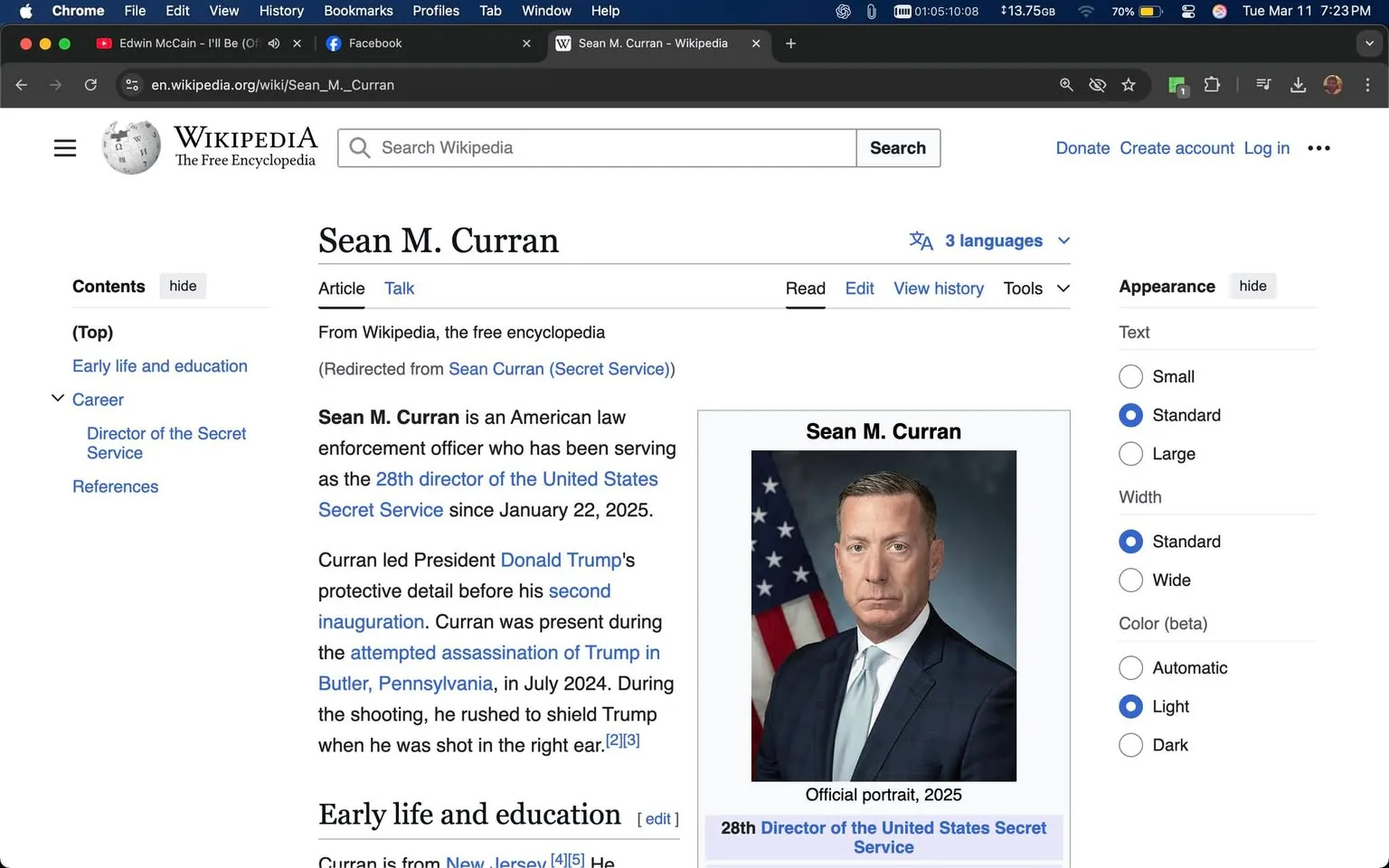 The image displays a Wikipedia page for Sean M. Curran, who is identified as the 28th director of the United States Secret Service. The page includes a header with the title "Sean M. Curran" prominently displayed at the top. Below the title, there is a brief introductory paragraph stating that he has been serving in this role since January 22, 2025, and mentions his previous involvement with President Donald Trump's protective detail.

On the right side of the page, there is an official portrait of Sean M. Curran. In this portrait, he is wearing a dark suit with a light blue tie, and he has short, neatly styled hair. The background of the portrait features the American flag, which is partially visible. The text "Official portrait, 2025" is noted beneath the image, along with his title as the "28th Director of the United States Secret Service."

The left sidebar includes sections labeled "Contents," "Early life and education," "Career," "Director of the Secret Service," and "References," indicating the structure of the article. The page also features options for adjusting the appearance settings, such as text size and color.

Overall, the image captures a structured and informative layout typical of a Wikipedia entry, focusing on Sean M. Curran's professional background and current role.