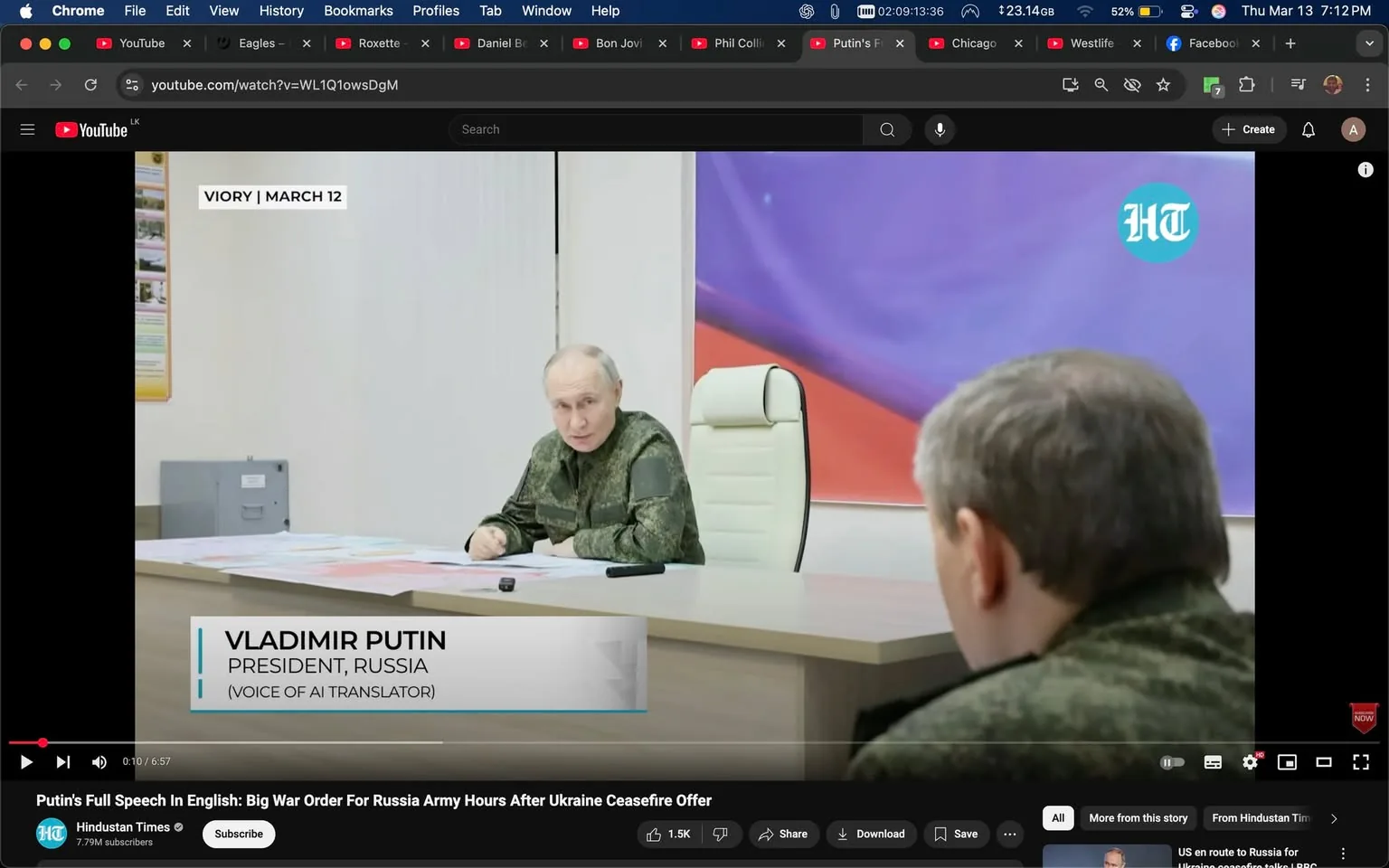 The image shows a scene from a video conference or meeting involving a man seated at a table. He appears to be Vladimir Putin, the President of Russia, identifiable by the text overlay that reads "VLADIMIR PUTIN, PRESIDENT, RUSSIA." He is wearing a military-style uniform that is predominantly green with a camouflage pattern. The uniform has a patch on the left sleeve, but the details of the patch are not visible.

Putin is seated at a light-colored wooden table that has several documents and maps spread out in front of him. He is leaning slightly forward, with his left hand resting on the table and his right hand gesturing as he speaks. His expression appears serious and engaged.

In the foreground, there is another individual whose back is visible. This person is also wearing a military-style uniform, but their face is not visible. The background features a white wall with a colorful abstract design, predominantly in shades of purple and orange. There is a large white chair behind Putin, which is modern in design.

To the left of the image, there is a gray object that appears to be a filing cabinet or storage unit, but it is not clearly defined. The overall setting appears to be a formal meeting room, likely within a government or military context, given the attire and the nature of the discussion.

The video interface at the bottom includes a play button and a timestamp indicating the duration of the video, which is 6 minutes and 57 seconds. There is also a logo in the top right corner that appears to belong to a news outlet, possibly indicating the source of the video. The text "VOICE OF AI TRANSLATOR" suggests that the video may include translated audio. 

The image captures a moment of a significant discussion, likely related to military or political matters, given the context and attire of the individuals involved.