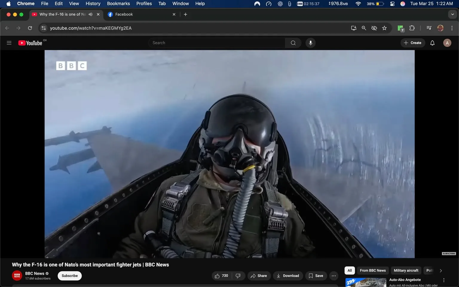 The image depicts a cockpit view of a fighter jet, specifically an F-16, with a pilot visible in the foreground. The pilot is wearing a full-face helmet with a visor, which reflects the cockpit environment. The helmet includes a breathing apparatus connected by a tube, indicating the high-altitude conditions of flight. The pilot is dressed in a military flight suit, which is olive green and features various straps and buckles for securing equipment.

In the background, the cockpit's control panel is partially visible, showcasing various instruments and displays typical of a fighter aircraft. The view outside the cockpit reveals a clear blue sky with some clouds, suggesting the aircraft is flying at a high altitude. The wing of the jet is visible, extending out towards the left side of the image, with a missile or fuel tank mounted beneath it.

The image includes branding from the BBC, located in the upper left corner, with the letters "BBC" in white against a transparent background. Additionally, there is a title at the bottom of the image stating, "Why the F-16 is one of NATO's most important fighter jets | BBC News," along with a channel logo and subscriber count for BBC News in the lower left corner.

The overall setting indicates a military aviation context, likely during a training or operational flight, with a focus on the capabilities of the F-16 fighter jet. The image captures a moment of aerial maneuvering, emphasizing the pilot's role in operating advanced military aircraft.