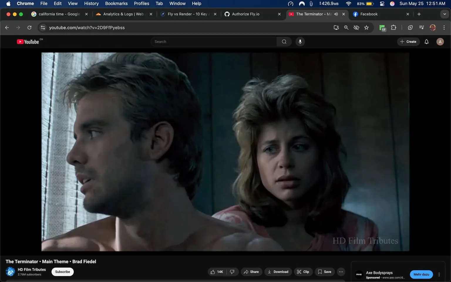 The image depicts a scene from a film featuring two characters. On the left, a man with short, light brown hair and a stubbled jawline is seen in profile. He has a serious expression, and his bare shoulder is visible, indicating he is not wearing a shirt. The lighting highlights the contours of his face and the texture of his hair.

To the right, a woman with medium-length, wavy hair, styled in a voluminous manner, appears to be looking at the man. She has a concerned expression, with her eyebrows slightly furrowed and her lips pressed together. She is wearing a light pink top with a simple design, which contrasts with the darker background. 

The background features a wooden wall, suggesting an indoor setting, possibly a cabin or a room with rustic decor. Natural light filters through sheer curtains, casting soft shadows and creating a somewhat somber atmosphere. The overall color palette is muted, with shades of gray and brown dominating the scene.

There are no visible logos, text, or identifiable brands in the image. The focus remains on the characters and their expressions, with no additional objects or products present in the frame. The scene conveys a moment of tension or emotional significance, but no further context is provided.
