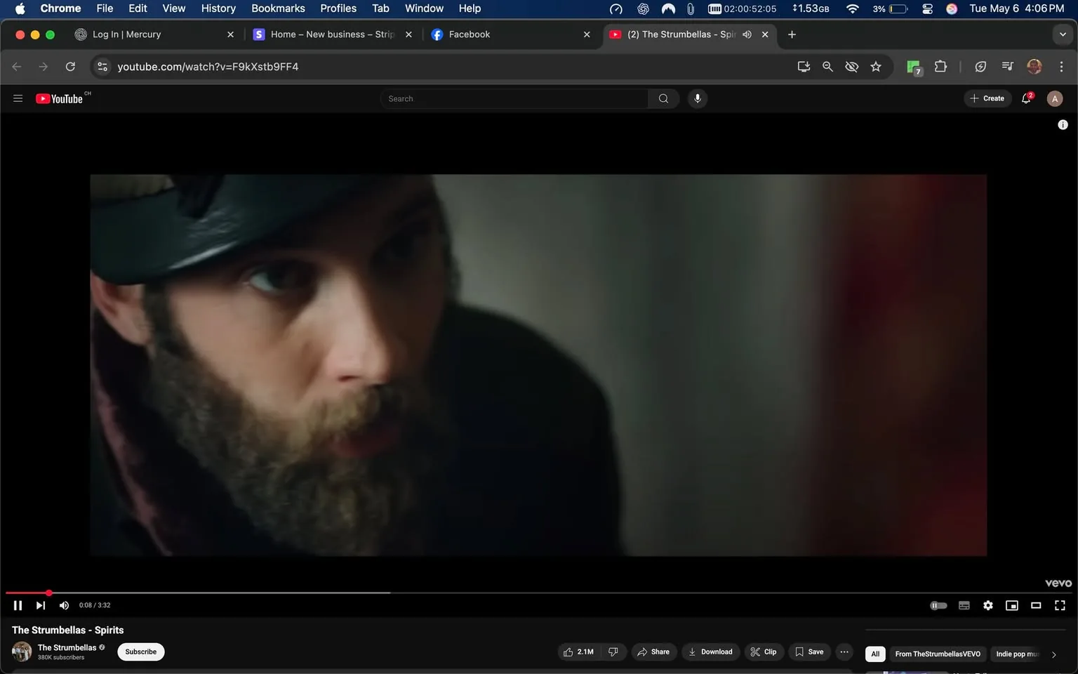 The image shows a close-up of a man with a prominent beard and mustache. He has a serious expression on his face, with his mouth slightly open as if he is speaking or reacting to something. His eyes are focused and intense, suggesting engagement in a conversation or situation. 

He is wearing a dark-colored coat or jacket, which appears to have a collar that is turned down. On his head, he has a black cap, possibly a military-style or newsboy cap, which adds to his rugged appearance. The background is slightly blurred, indicating that the focus is on the man. The colors in the background are muted, with hints of gray and red, suggesting an indoor setting, possibly a room with soft lighting.

The image is framed in a way that emphasizes the man's facial features, particularly his beard and eyes, while the rest of his body is not fully visible. There are no visible logos, text, or other identifiable features in the image. The overall mood conveyed by the man's expression is one of seriousness or contemplation, but no specific emotions or intentions can be inferred.

This image appears to be a still from a video, as indicated by the player controls visible at the bottom, which include a play button, volume control, and a timeline showing the video's duration. The video is titled "The Strumbellas - Spirits," suggesting it is related to a music video or performance.