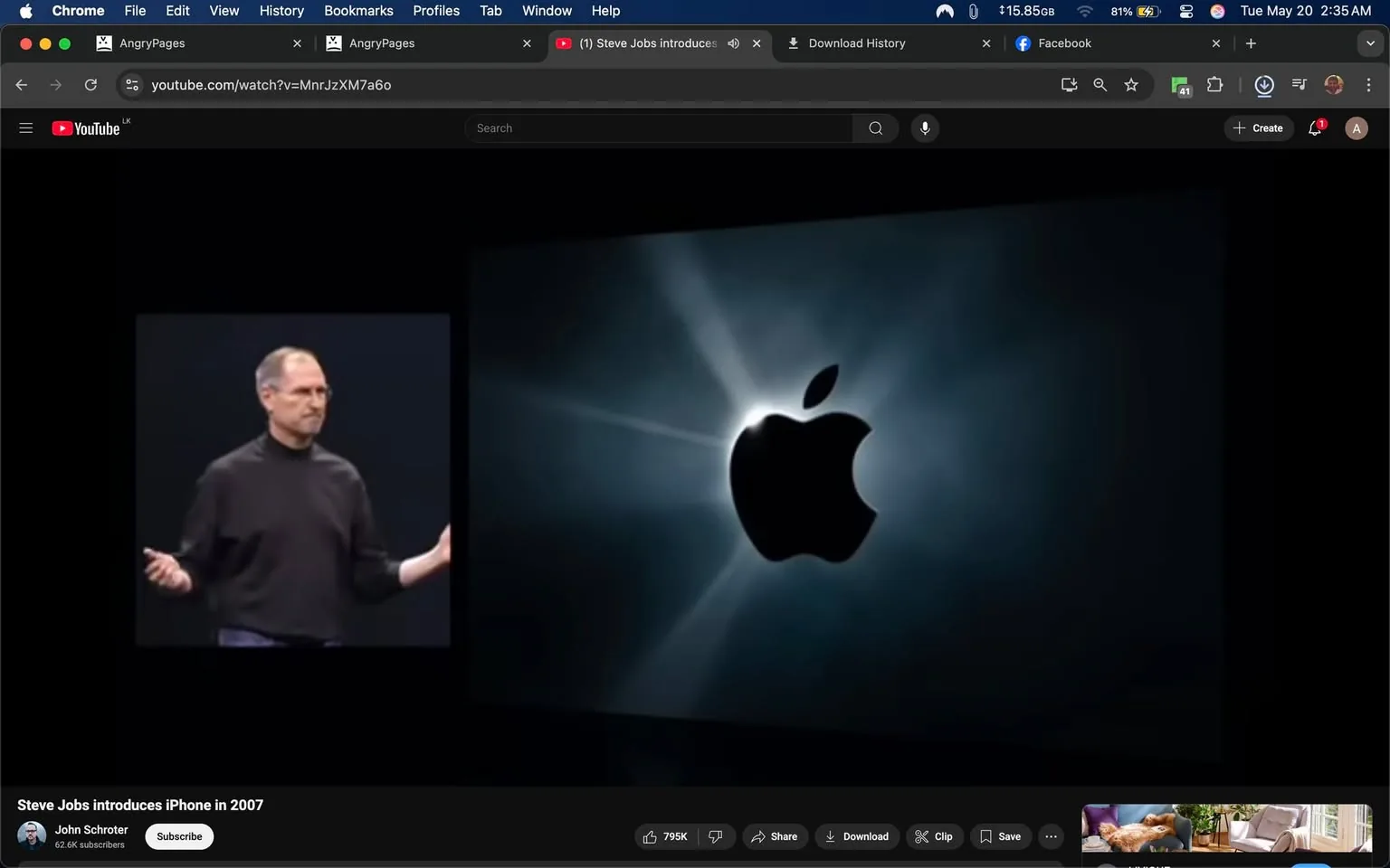 The image depicts a presentation scene featuring a man on the left side of the frame, who appears to be giving a talk. He is wearing a black turtleneck sweater and has short, slightly graying hair. His facial expression is neutral, and he is gesturing with both hands, indicating engagement with the audience. The background behind him is dark, likely a stage setting, with a spotlight effect illuminating him.

On the right side of the image, there is a large graphic of the Apple logo, which is prominently displayed against a dark background. The logo is white with a slight glow effect, surrounded by a burst of light that creates a dramatic visual impact. The background appears to have a gradient effect, transitioning from dark to lighter shades, enhancing the prominence of the logo.

At the bottom of the image, there is a YouTube interface visible, indicating that this is a video presentation. The title of the video reads "Steve Jobs introduces iPhone in 2007," suggesting that the man on stage is Steve Jobs, a well-known public figure associated with Apple Inc. The video has a view count of 795K and includes options to share, clip, and download.

The overall setting appears to be a tech event or product launch, likely related to Apple, given the presence of the logo and the context of the presentation. The image captures a moment of significant historical importance in the tech industry, as it relates to the introduction of the iPhone.