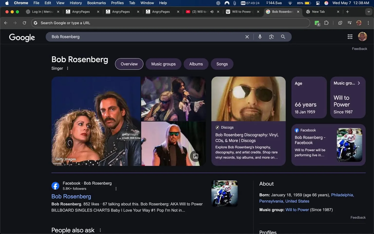 The image displays a Google search results page for "Bob Rosenberg." At the top, the search bar shows the query. Below it, the name "Bob Rosenberg" is prominently featured, identified as a "Singer." 

To the left, there are several images of a man with long hair, often wearing sunglasses and a leather jacket, alongside a woman with curly hair and large earrings. The images appear to be from performances or promotional materials. The woman is wearing a black and white polka dot dress, while the man has a mustache and is dressed in a black outfit.

On the right side, there is a sidebar with various details about Bob Rosenberg, including his age (66 years), date of birth (January 18, 1959), and a mention of his music group, "Will to Power," which has been active since 1987. There is also a link to his Facebook page, which indicates he has over 5.8k followers.

The bottom section includes a brief overview stating that Bob Rosenberg is also known as "Will to Power" and mentions his Billboard singles chart success with the song "Baby I Love Your Way." 

The background of the page is dark, consistent with a night mode theme, and there are various tabs open in the browser, including "AngryPages" and a YouTube link. The overall layout is typical of a Google search results page, with clear sections for images, information, and links.