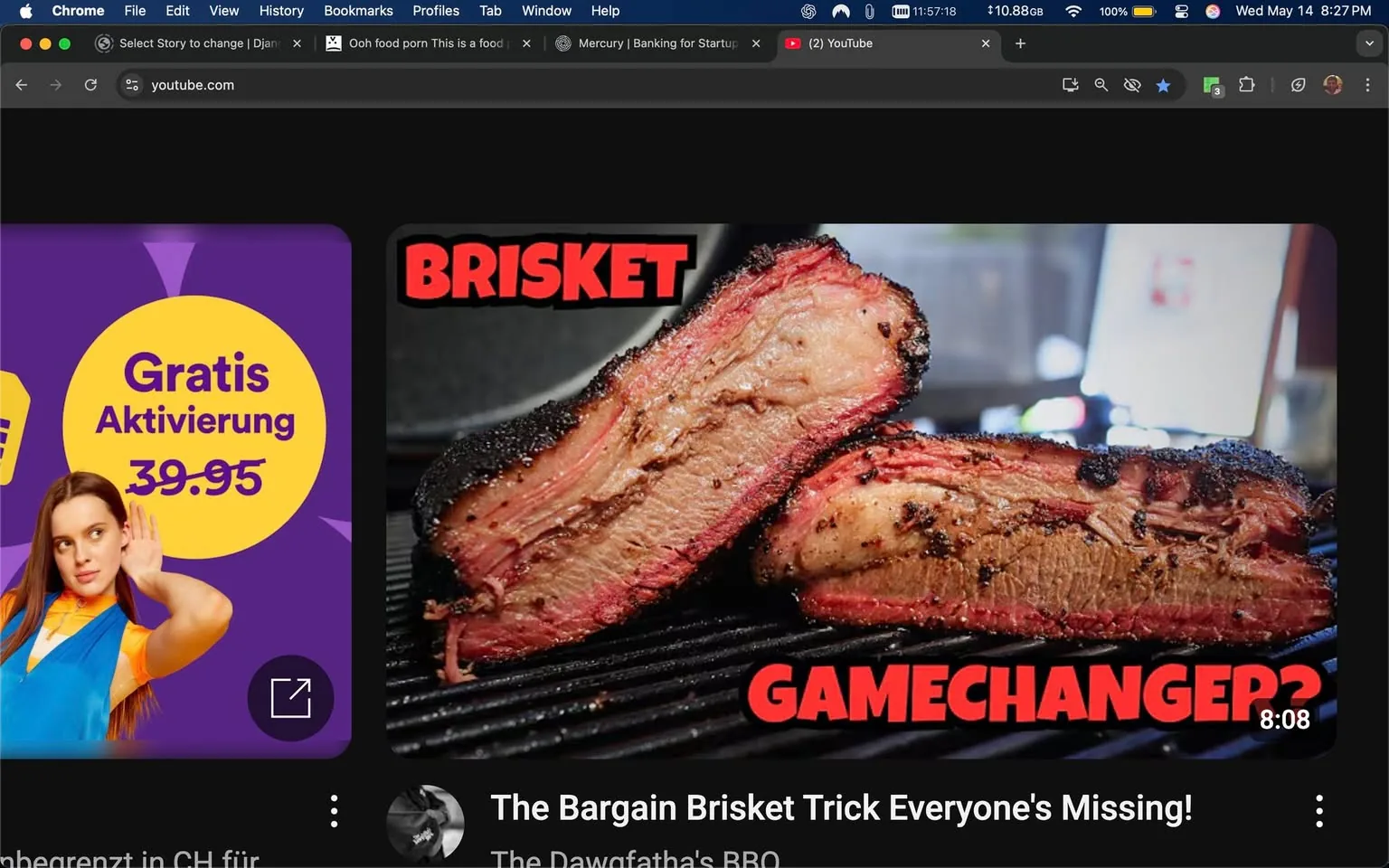 The image displays a YouTube interface featuring a video thumbnail prominently showcasing brisket. The brisket appears to be sliced, revealing a juicy interior with a pinkish hue, surrounded by a dark, charred crust. The text overlay on the thumbnail reads "BRISKET" in bold, red letters, with the word "GAMECHANGER?" also in red, positioned below the main title. The background of the thumbnail is slightly blurred, suggesting a cooking or grilling environment, possibly with a grill or smoker in use.

To the left of the thumbnail, there is a purple advertisement featuring a circular yellow badge that states "Gratis Aktivierung" with a price of "39.95" below it. The advertisement includes a young woman with long hair, wearing a blue and orange outfit, who appears to be listening or paying attention, indicated by her hand raised to her ear.

The overall setting of the image is a dark-themed YouTube interface, with the video thumbnail being the focal point. The time displayed in the top right corner shows "11:57:18," and the date is noted as "Wednesday, May 14." The video duration is indicated as "8:08" at the bottom of the thumbnail, suggesting it is a cooking or BBQ-related video.

No identifiable people or specific brands are present in the image aside from the YouTube logo and the visible elements of the advertisement. The overall aesthetic is visually appealing, aimed at attracting viewers interested in cooking, particularly BBQ and brisket preparation.