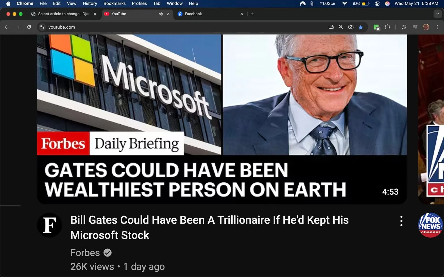 The image features a split layout with two main sections. 

On the left side, there is a large building with a sign displaying the Microsoft logo. The logo consists of four colored squares: red, green, blue, and yellow, arranged in a 2x2 grid. The building has a modern architectural design with large glass windows, reflecting the sky and surrounding environment. The overall color scheme of the building appears to be predominantly dark, likely black or dark gray.

On the right side, there is a close-up image of a man, who appears to be smiling. He has short, light-colored hair and is wearing rectangular glasses. His attire includes a light blue dress shirt with a dark tie that has a pattern, and a gray suit jacket. The background behind him is blurred, but it appears to be a light-colored setting, possibly outdoors or in a well-lit indoor space.

At the top of the right section, there is text that reads "Forbes Daily Briefing" in a red box, indicating the source of the information. Below this, in bold white text, it states, "GATES COULD HAVE BEEN WEALTHIEST PERSON ON EARTH." 

At the bottom of the image, there is additional text that reads, "Bill Gates Could Have Been A Trillionaire If He'd Kept His Microsoft Stock," along with a timestamp of "4:53" indicating the length of a video. The text is in white against a black background, making it stand out.

In the bottom left corner, there is a small "F" logo, indicating the Forbes brand, and a view count of "26K views" along with a timestamp of "1 day ago." 

Overall, the image combines elements of corporate branding, personal imagery, and informative text related to financial speculation about Bill Gates and Microsoft.