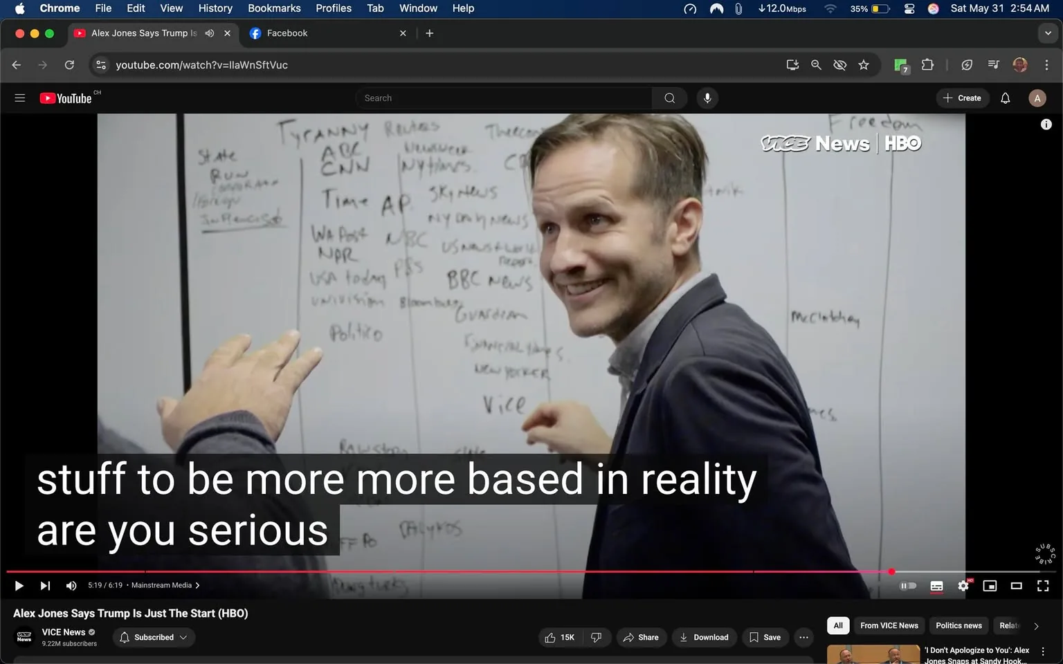 The image features a scene from a video, likely an interview or discussion, with a whiteboard in the background filled with handwritten notes. The whiteboard contains various names and terms, including "Tyranny," "ABC," "CNN," "Time," "AP," "NBC," "USA Today," "Politico," and others, suggesting a focus on media outlets or news organizations. The notes appear to be organized into categories, possibly related to a specific topic or discussion theme.

In the foreground, a man is smiling and gesturing with his hands. He has short, light-colored hair and is wearing a dark blazer over a light-colored shirt. His expression is friendly and engaged, indicating he is actively participating in the conversation. His left hand is raised, and he appears to be pointing or emphasizing a point, while his right hand is positioned near his chest.

The background is primarily white due to the whiteboard, which dominates the scene. The setting appears to be an indoor space, possibly an office or studio, given the professional attire of the individual and the presence of the whiteboard. The lower part of the image includes a video player interface with a timestamp indicating 5:19 out of a total of 6:19, along with a title that reads "Alex Jones Says Trump Is Just The Start (HBO)" and a logo for VICE News. There are also visible buttons for sharing, downloading, and subscribing, indicating this is a video platform interface.

Overall, the image captures a moment of discussion or brainstorming, with a focus on media and political themes, as indicated by the content on the whiteboard and the context of the video.
