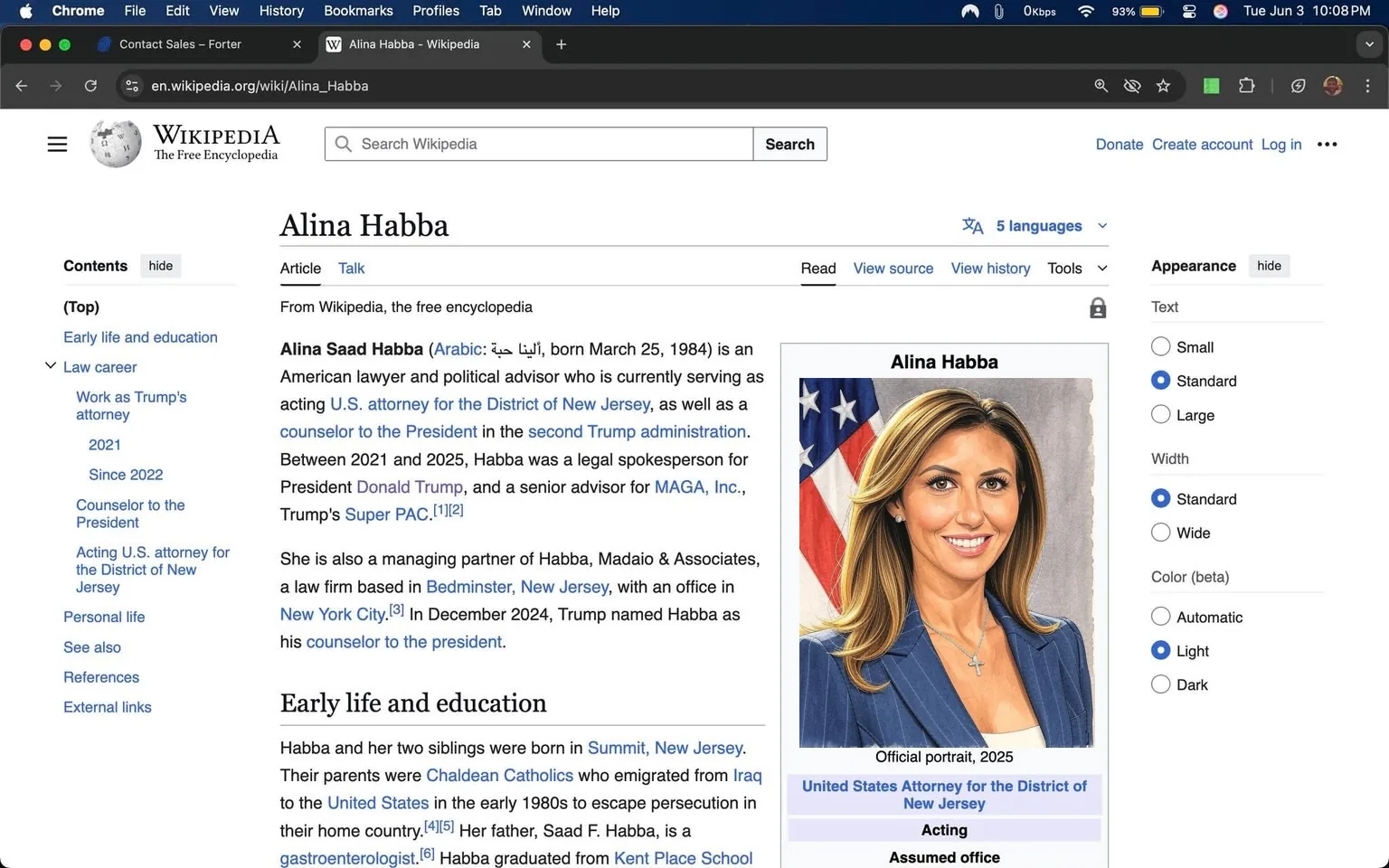 The image displays a Wikipedia page titled "Alina Habba." The page features a portrait of Alina Habba on the right side, which is labeled as her official portrait from 2025. She has long, wavy brown hair and is wearing a black blazer over a white top. A silver cross necklace is visible around her neck. The background of the portrait includes the American flag, which is partially visible.

To the left of the portrait, the text provides a brief introduction about Alina Habba, stating her full name, birth date (March 25, 1984), and her profession as an American lawyer and political advisor. It mentions her current roles, including acting U.S. attorney for the District of New Jersey and counselor to the President in the second Trump administration. The text also notes her previous work as a legal spokesperson for President Donald Trump and her position as a senior advisor for MAGA, Inc., and Trump's Super PAC.

The page is structured with headings such as "Early life and education" and "Law career," indicating sections that provide more detailed information about her background and professional journey. The layout includes a table of contents at the top, which allows for navigation through different sections of the article.

The background of the page is white, with a standard Wikipedia layout that includes links to other languages and options for text size and color. The header features the Wikipedia logo and a search bar. The overall design is clean and organized, typical of Wikipedia's format.