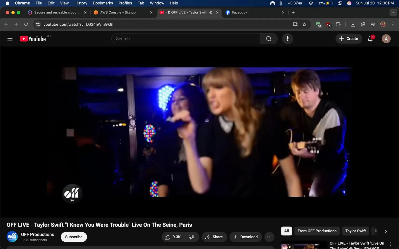 The image shows a live performance featuring a female singer in the foreground, who appears to be passionately singing into a microphone. She has long, wavy blonde hair and is wearing a black outfit with a white collar, suggesting a stylish yet casual look. Behind her, a woman with dark hair is also holding a microphone, contributing to the performance. To the right, a male guitarist is seated, playing an acoustic guitar, dressed in a black and white top.

The background features colorful stage lights, creating a vibrant atmosphere. The overall tone of the image is energetic and engaging, reflecting the excitement of a live music event. The singer's expression is intense, conveying strong emotions, possibly related to the song's themes of trouble or heartbreak. 

The video is branded with the logo of "OFF Productions," indicating it is a professional recording. The context suggests a performance of Taylor Swift's song "I Knew You Were Trouble," which may evoke discussions around relationships and emotional experiences.