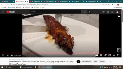 ```
**SECTION 2: Rich Description**
The screenshot captures a scene from a YouTube video titled "Air Fryer Char Siu Chinese BBQ Roast Pork Recipe (空气炸叉烧) Using Lee Kum Kee (李锦记) Sauce | Rack of Lam." This video is hosted on the Rack of Lam channel. The scene shows a close-up of a piece of char siu, a type of Chinese BBQ roast pork, which is presented on a white rectangular plate. The pork appears caramelized and glossy, showing the rich, reddish-brown hue characteristic of char siu. The meat is sliced, revealing succulent layers and a glistening surface, indicating it’s freshly cooked.
A fork is seen on the left side of the pork, suggesting that it has just been used to slice the meat, which is lying in a pool of its own juices on the plate. The setting appears to be a kitchen countertop, judging by the marble texture in the background. The lighting is bright and warm, enhancing the appetizing look of the dish. The YouTube interface elements are visible, including the title and progress bar at the bottom of the screen, indicating that the video is at the 8:44 mark out of 10:09. Tags below the video suggest it's related to Chinese cuisine, emphasizing the use of an air fryer for cooking.
- Title: "Air Fryer Char Siu Chinese BBQ Roast Pork Recipe (空气炸叉烧) Using Lee Kum Kee (李锦记) Sauce | Rack of Lam"
- Channel / profile: "Rack of Lam"
- Site / app: "YouTube"