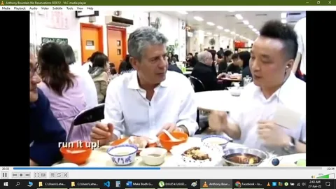 In this video frame from "Anthony Bourdain No Reservations," Anthony Bourdain is seated at a bustling restaurant table, engaged in conversation with another individual. The setting is lively and filled with diners in the background, suggesting a popular dining spot. Bourdain, known for his culinary adventures, is wearing a white shirt and appears to be in a relaxed, engaged conversation, indicating a discussion perhaps about the food or the cultural experience.
The table is filled with a variety of dishes, showcasing the diverse and rich cuisine Bourdain is likely exploring. Bright colors from the food contrast with the neutral tones of the restaurant's interior, adding vibrancy to the scene. The subtitle "run it up!" hints at an enthusiastic or lively discussion, possibly about the food being enjoyed.
The overall mood is one of discovery and appreciation, typical of Bourdain's style in "No Reservations," where he delves into the local food culture with curiosity and respect. The lighting is bright, highlighting the details of the food and the faces of the diners, enhancing the welcoming and inclusive atmosphere of the restaurant setting.
- Title: "Anthony Bourdain No Reservations S03E12 - VLC media player"
- Captions / subtitles: "run it up!"