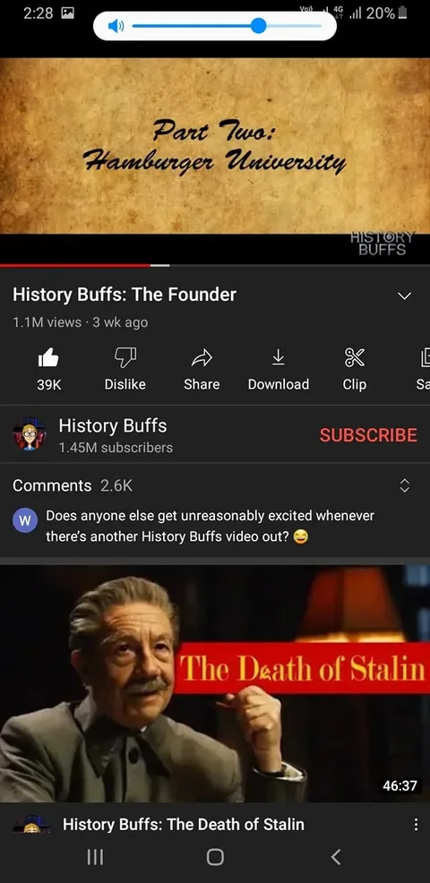 The screenshot shows a YouTube video titled "History Buffs: The Founder" on the channel History Buffs, which has 1.45 million subscribers. The video has amassed 1.1 million views in three weeks and has 39,000 likes. The channel is known for analyzing historical films, and this episode focuses on "The Founder." A text overlay in the video itself reads "Part Two: Hamburger University," suggesting a segment or chapter in the video. Below the title, there's a comment from a viewer expressing excitement about new History Buffs videos.
The interface displays typical YouTube elements such as like, dislike, share, download, and clip buttons. Below the main video details, a thumbnail for another video titled "The Death of Stalin" is visible, showing an older gentleman in a suit, possibly related to the film being discussed. The video's duration is 46:37. The overall color scheme includes earthy tones with an emphasis on browns and reds, which contribute to a scholarly or vintage look, fitting for historical content.