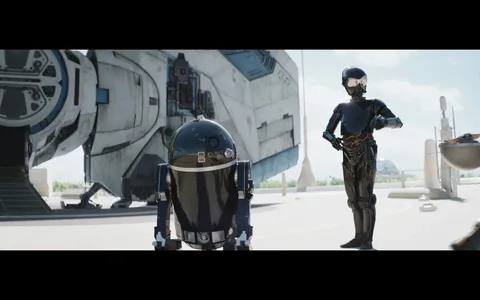 A scene from the "Star Wars" universe features two droids and part of a spaceship. In the foreground, an astromech droid, reminiscent of the iconic R2-D2 but in a sleek black color, stands on the left. Its dome-shaped head and cylindrical body reflect the bright sunlight. To the right, a humanoid protocol droid, also in a shiny black finish, stands with one arm bent and resting on its hip, suggesting an air of attentiveness or readiness. The reflective surfaces of both droids emphasize the high-tech, futuristic setting.
In the background, a large spaceship with a rugged, well-used appearance is visible. Its design is characteristic of the "Star Wars" aesthetic, with visible panels and industrial detailing. The scene is set outdoors, under a clear blue sky, with tall spires visible in the distance, hinting at a spaceport or futuristic cityscape. The lighting is bright, casting clear shadows on the ground, enhancing the scene's sense of realism.
- Title: "..."
- Channel / profile: "..."
- Site / app: "..."
- Captions / subtitles: "..."