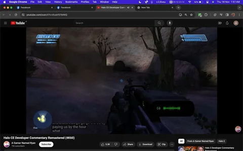 The screenshot captures a YouTube video titled "Halo CE Developer Commentary Remastered (4K60)" from the channel "A Gamer Named Ryan." The video displays gameplay footage of "Halo," specifically in a first-person shooter format. The player character is aiming a weapon in an outdoor setting, depicted with rocky terrain and sparse trees under dim lighting. The game's user interface is visible, showing health and shield indicators, ammunition count, and a radar at the bottom left. The on-screen text includes a small portion of subtitles, reading "paying us by the hour," suggesting dialogue or commentary. The image shows that this is an active gameplay moment with a reticle centered on the screen, indicative of the player preparing to engage. The desktop view includes browser tabs and a visible URL link for the video, enhancing the context of this being a screen capture from a viewer's perspective.
- Title: "Halo CE Developer Commentary Remastered (4K60)"
- Channel / profile: "A Gamer Named Ryan"
- Site / app: "YouTube"
- Captions / subtitles: "paying us by the hour"