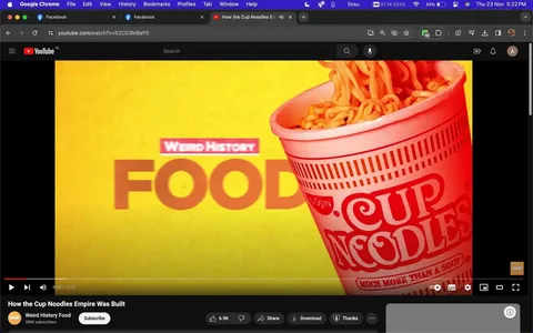 The image is a screenshot from a YouTube video titled "How the Cup Noodles Empire Was Built." The video is shared by the channel "Weird History Food," which has 389,000 subscribers. The screenshot features a bright yellow background with a prominent image of a cup of noodles on the right side. The noodles are spilling over the top of the cup, which features red branding text that reads "CUP NOODLES" and "MUCH MORE THAN A SOUP." In the center-left of the image, in red, there are the words "Weird History" above the large bold word "FOOD." The YouTube interface is visible, showcasing options like subscribe, like, share, download, and thanks, indicating viewer engagement with 6.9K likes. The browser tabs visible at the top show other open websites, including two tabs of Facebook. The visual conveys a colorful and engaging introduction to the video's content about the history of Cup Noodles, emphasizing branding and historical context.