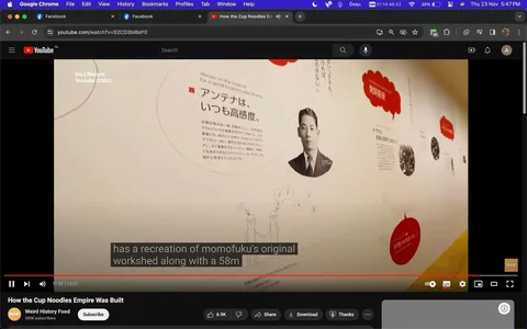 The image is a screenshot from a YouTube video titled "How the Cup Noodles Empire Was Built," featured on the "Weird History Food" channel. It shows a museum exhibit wall dedicated to the history of Cup Noodles. The wall displays various text and images, including a historical photograph of a man, likely related to the founding of Cup Noodles, due to the mention of "momofuku" in the subtitles. Text in both English and Japanese is visible. An English sentence reads, "Always on the lookout for a great business opportunity." The design includes speech bubbles and drawings, adding a dynamic, informative aesthetic to the display.
The exhibit appears well-lit, with a focus on educational content about business opportunities and historical insights. The video caption mentions a recreation of "momofuku's original workshed," suggesting a detailed exploration of the brand's origins. The setting is likely inside a museum or a similar educational venue, emphasizing the cultural and historical impact of Cup Noodles.