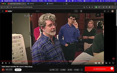 The image is a screenshot from a YouTube video titled "Halo's Music And Why We Love It | Video Essay," featured on the channel Laper Larden. The scene takes place indoors, possibly during a meeting or discussion. The central figure, referred to in the hint as Lucas, is wearing a blue plaid shirt and appears to be speaking or listening intently. Several people are gathered around, with one person in a blue shirt and glasses touching their face thoughtfully. Another individual, wearing a green sweater, stands with arms crossed, showing interest in the conversation. The setting suggests a professional or collaborative environment, as indicated by the serious expressions and attentive postures of the attendees. The room is warmly lit, with bookshelves and a whiteboard visible in the background. The video discusses the music of the "Halo" series, focusing on its emotional impact, as reflected in the subtitle "Emotional Equity" visible on screen.