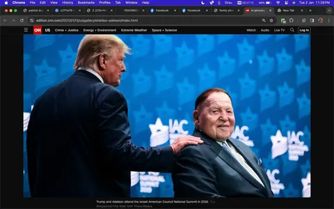 ```
Sheldon Adelson is seen at an event, possibly the Israeli American Council National Summit in 2019, as identified by the backdrop. The image captures a moment between two men in suits, with one placing a hand on the shoulder of the other. The backdrop is blue, decorated with star motifs and the text "IAC National Summit 2019," indicating the event's context. The man standing has his back turned, while Sheldon Adelson is seated and looking towards the camera with a slight smile. The lighting is bright, emphasizing the formal event setting. Adelson is wearing a dark suit with a light blue tie, adding to the formal atmosphere. The composition focuses on the interaction between the two figures, highlighting a moment of acknowledgment or camaraderie.
- Title: "In pictures: Sheldon Adelson"
- Site / app: "CNN"
- Captions / subtitles: "Trump and Adelson attend the Israeli American Council National Summit in 2019."