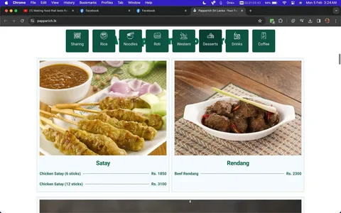 This screenshot is from the website papparich.lk, showing a section of a menu from Papparich Sri Lanka, a restaurant specializing in Malaysian cuisine. The upper part of the image includes a navigation bar with categories like Sharing, Rice, Noodles, Roti, Western, Desserts, Drinks, and Coffee. Below, there are two main dishes featured with images and prices.
On the left is a dish labeled "Satay," consisting of skewered and grilled chicken served with a side of peanut sauce, garnished with cucumber and onion slices. The menu offers Chicken Satay in options of six sticks for Rs. 1850 and twelve sticks for Rs. 3100.
On the right is the "Rendang," a dish featuring beef with rich, spicy seasoning, presented in a white serving dish. The price for Beef Rendang is Rs. 2300. The presentation is simple and emphasizes the traditional Malaysian flavors, with a rustic setting featuring wooden surfaces and woven placemats. The overall aesthetic is clean and appetizing, highlighting the savory nature of these dishes.