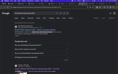 1) Rich description (8–12 sentences): The screenshot is a display of a Google search result page for "World Barista Championship 2007." It shows a dark-themed user interface, typical of a browser in dark mode. At the top, the Google search bar contains the entered search term. Below it, the first search result is from the World Barista Championship's official site, featuring a PDF titled "2007 WBC Ranking Order - Without Company Names." Highlighted names include Heather Perry from the United States, who ranked second, and James Hoffman from the United Kingdom, who ranked third. The search results are accompanied by sections labeled "People also ask," suggesting common queries related to the championship. The screenshot also shows multiple open tabs at the top of the browser, including Facebook, YouTube, and other related searches. The time and internet connection status are visible in the top right corner. The entire visual is indicative of someone researching past barista competitions, likely in connection with the individuals named.
2) On-screen text block (only include lines that have real text; if a field is unknown or blank, omit that line entirely):
- Title: "World Barista Championship 2007 - Google Search"
- Site / app: "Google"
- Key OCR Lines:
- "World Barista Championship 2007"
- "2007 WBC Ranking Order - Without Company Names"
- "Heather Perry. United States of America. 706.00. Second."
- "James Hoffman. United Kingdom. 681.00. Third. Miyuki Miaymae."