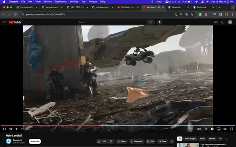 The image is a screenshot from a YouTube video titled "Halo Landfall" on the Bungie channel. It depicts a military sci-fi scene with intense action. In the foreground, armed soldiers are crouched behind a concrete barrier, taking cover. They appear to be wearing futuristic armor and helmets, which suggests a high-tech, combat-ready environment. The ground is littered with debris and dirt, adding to the gritty, war-torn atmosphere.
In the background, a large aircraft hovers near the soldiers, with the word "MARINES" visible on its side. This aircraft is in the process of deploying a vehicle, which is suspended mid-air, indicating a rapid military operation. The lighting is bright, suggesting a daytime setting, and the colors are predominantly muted earth tones, which is typical of a military setting.
The overall mood is tense and action-packed, characteristic of a combat scenario. The video seems to belong to the "Halo" franchise, known for its military science fiction themes. The visual style is realistic, catering to fans of immersive, high-stakes action.
- Title: "Halo Landfall"
- Channel / profile: "Bungie"
- Site / app: "YouTube"