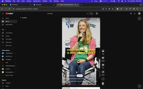 The image is a screenshot from a YouTube short titled "Master Chief's McDonald's Order." It features Jen Taylor, known for her role in "Halo 3." She is seated on a panel, holding a microphone with a friendly expression. Jen is wearing a green t-shirt with a pink cardigan over it, and jeans, sitting comfortably on a director-style chair. The backdrop includes branding from a convention, possibly "GalaxyCon," as indicated by the visible logos. The lighting is bright, typical of an indoor panel setting. The overlay text humorously questions, "CHIEF WOULD DRINK A SMALL DIET COKE?" indicating a lighthearted discussion or Q&A session. The video is associated with the channel "@SteveDownes117," who is linked to the character Master Chief. The scene captures a moment from a fan convention or event related to the "Halo" series, with fans likely in attendance.
- Title: "Master Chief's McDonald's Order"
- Channel / profile: "@SteveDownes117"
- Site / app: "YouTube"
- Captions / subtitles: "CHIEF WOULD DRINK A SMALL DIET COKE?"