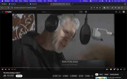 Ron Perlman is depicted in a recording studio setting, focusing intently on his work behind a microphone. He wears large over-ear headphones and glasses, indicating a concentrated effort typical in a voice acting session. The room is relatively dimly lit, providing a subdued and professional atmosphere. Perlman is captured in mid-sentence, suggesting active engagement with his lines.
Positioned prominently in the foreground is a professional microphone setup, complete with a pop filter, suggesting a high-quality audio recording environment. Behind him, a blurred, abstract mural adds a touch of creativity to the otherwise plain studio walls.
The on-screen text identifies Ron Perlman as the "Voice of Lord Hood," a character from the video game "Halo 3." This screenshot is taken from a YouTube video titled "The Voice Acting in Halo 3," uploaded by the channel "HALO CODEX." The image effectively captures a moment of the creative process in video game production, highlighting the behind-the-scenes efforts of voice actors like Perlman.
- Title: "The Voice Acting in Halo 3"
- Channel / profile: "HALO CODEX"
- Site / app: "YouTube"