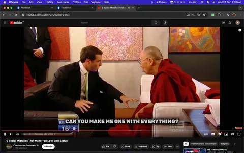 The image is a screenshot from a YouTube video titled "6 Social Mistakes That Make You Look Low Status," featured on the "Charisma on Command" channel. In this indoor interview setting, a man in a suit is seated opposite the Dalai Lamai, who is wearing traditional red robes. They are engaged in conversation, with the man leaning forward, seemingly emphasizing a point or asking a question. The Dalai Lamai listens attentively.
The room is well-lit, with colorful abstract art on the walls adding a vibrant backdrop. A text overlay at the bottom reads, "CAN YOU MAKE ME ONE WITH EVERYTHING?" suggesting a humorous or philosophical exchange. The atmosphere is formal yet relaxed, reflecting an environment of thoughtful dialogue. The video frame indicates a pause at 6:02 out of an 11:30 duration, and the YouTube interface is visible, showing options to like, share, save, and more. The viewer is watching on a browser with multiple tabs open, including Facebook.