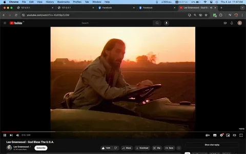 In this screenshot from YouTube, a scene from the music video "God Bless The U.S.A." by Lee Greenwood is displayed. The setting is a rural landscape at sunset, with warm, golden lighting that creates a serene and patriotic atmosphere. Lee Greenwood is seated on a tractor, appearing contemplative as he looks out over the farmland. He is dressed in a casual jacket, suitable for an outdoor setting. The composition of the shot emphasizes the vastness of the fields behind him, silhouetted against the setting sun. The YouTube interface shows the video controls at the bottom, including options to like, share, download, clip, and save the video. The channel, also named Lee Greenwood, has 57.5K subscribers, indicating a dedicated following. The visuals complement the patriotic theme of the song, enhancing its message of national pride and gratitude. The use of soft, natural lighting and the expansive landscape underscores the connection to the American heartland.
- Title: "Lee Greenwood - God Bless The U.S.A."
- Channel / profile: "Lee Greenwood"
- Site / app: "YouTube"