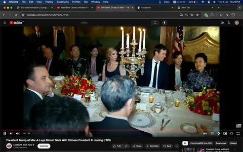 1) The image is a screenshot from a YouTube video titled "President Trump At Mar-A-Lago Dinner Table With Chinese President Xi Jinping (FNN)," on the channel LiveNOW from FOX. It shows a formal dining setting with a large, elegantly set table. The focus is on a group of people seated around the table, which is adorned with ornate candelabras and red floral arrangements. The individual identified as Jared Kushner is visible, seated next to a woman in a dark dress. The atmosphere is formal, with individuals dressed in suits and formal attire. The lighting is warm, creating an inviting and sophisticated ambiance. An American flag is visible in the background, highlighting the political context of the gathering. The attendees appear engaged and smiling, suggesting a cordial and sociable environment. The scene captures a moment of diplomatic interaction, reflective of the event's significance.
2)
- Title: "President Trump At Mar-A-Lago Dinner Table With Chinese President Xi Jinping (FNN)"
- Channel / profile: "LiveNOW from FOX"
- Site / app: "YouTube"